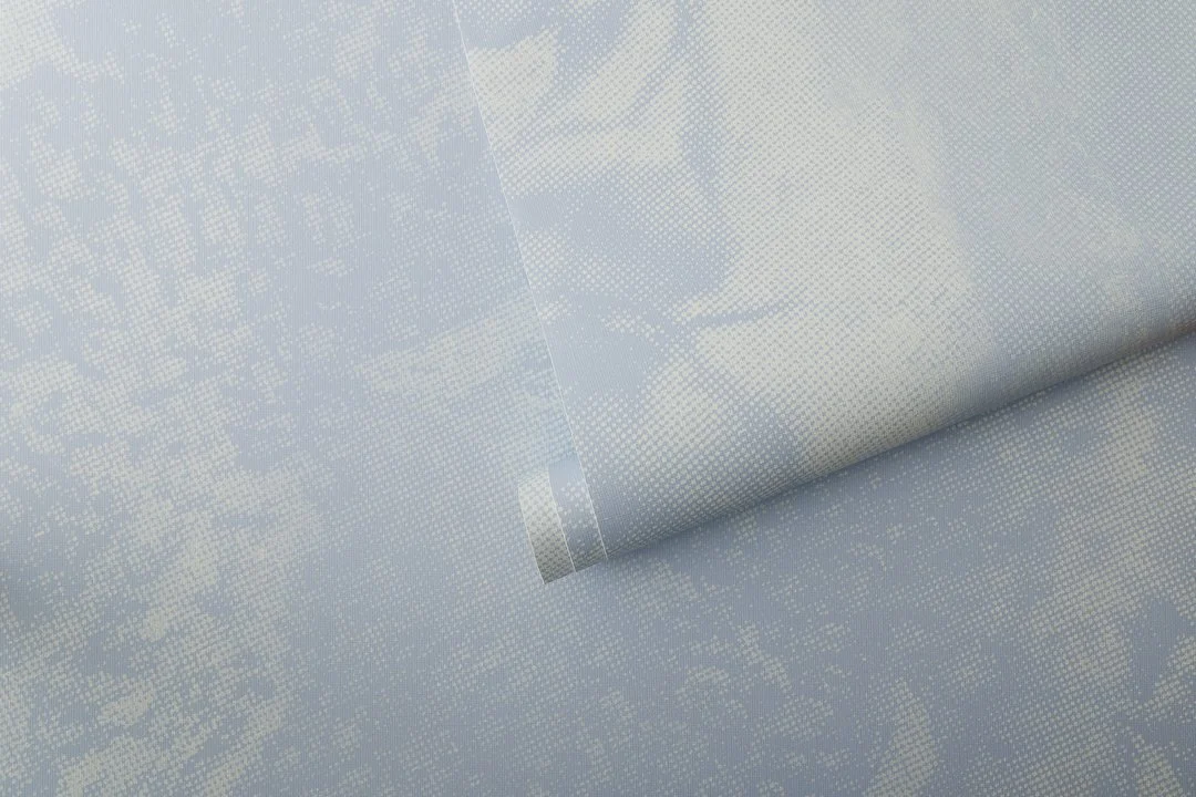 A roll of light blue wallcovering.