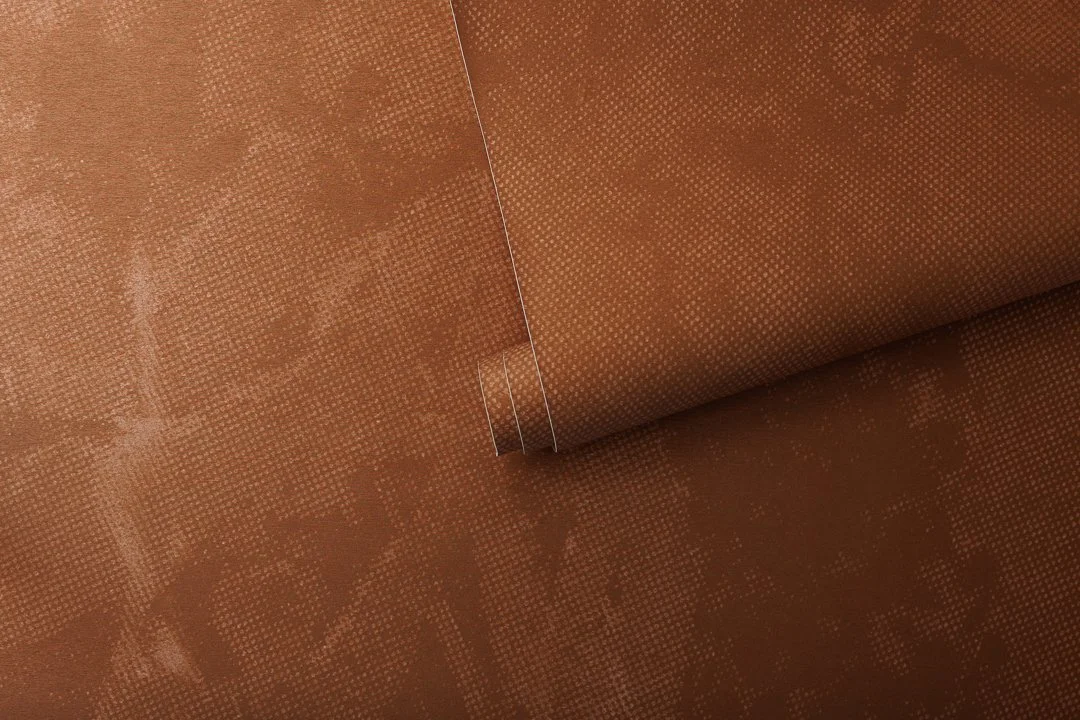 A roll of metallic orange wallpaper.