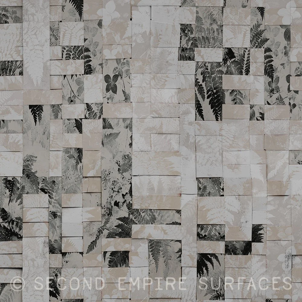 A black and grey woven pattern swatch with a subtle botanical motif.