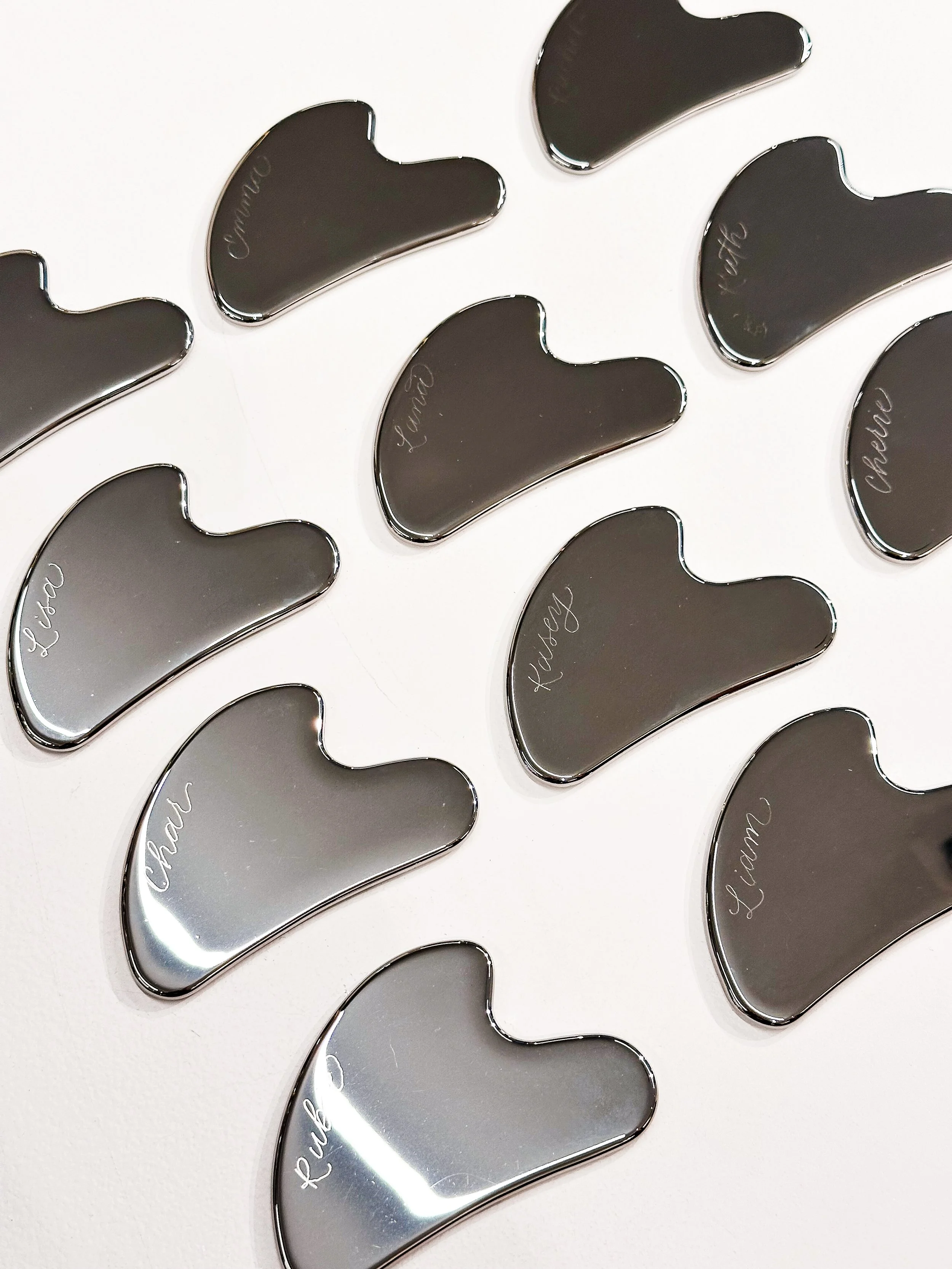 Live event engraving on metal gua sha stones for wellness brand activation event in Los Angeles