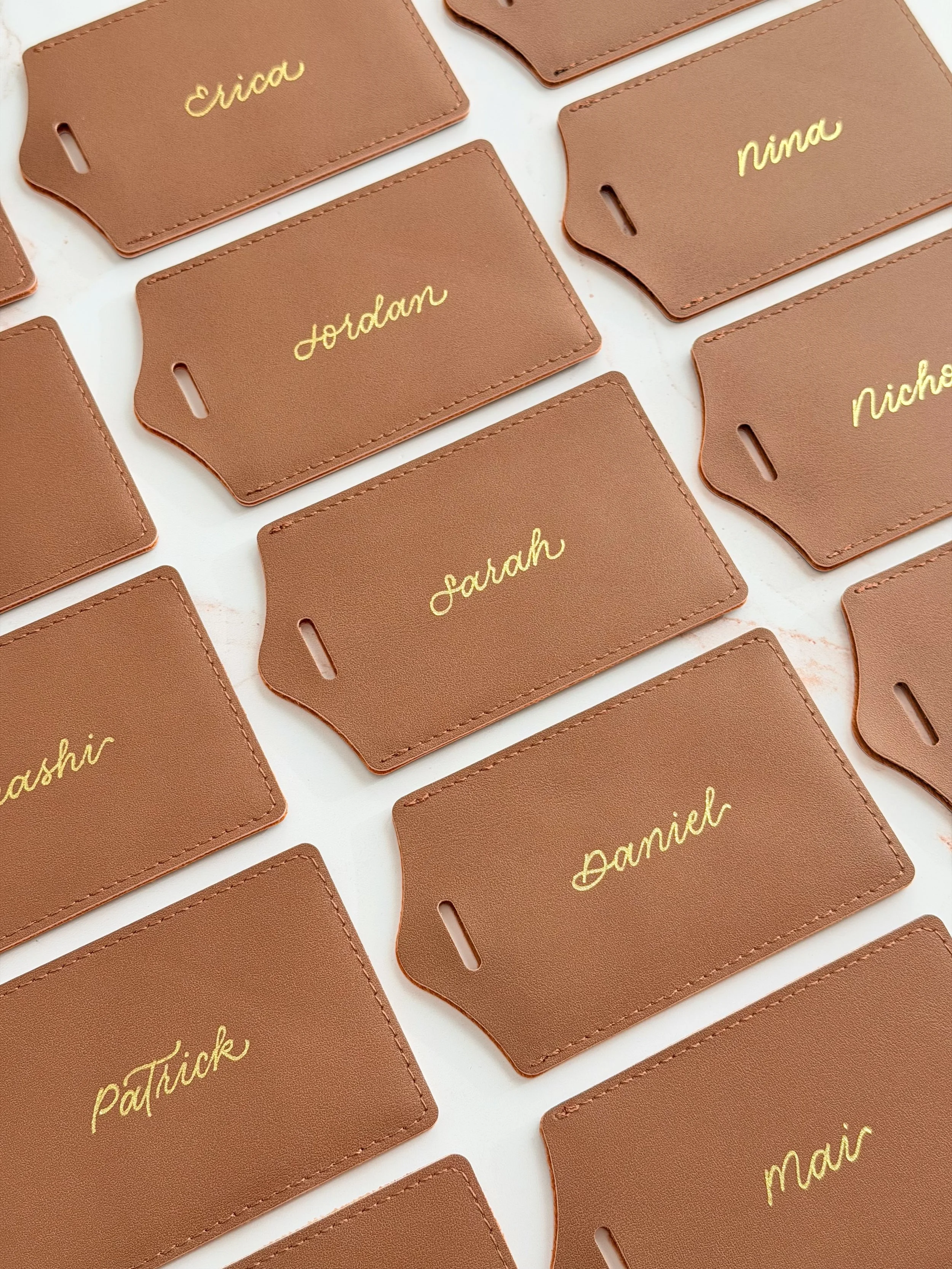 Live Hot Foiling and Debossing on leather luggage tags for brand activation gifting in Los Angeles