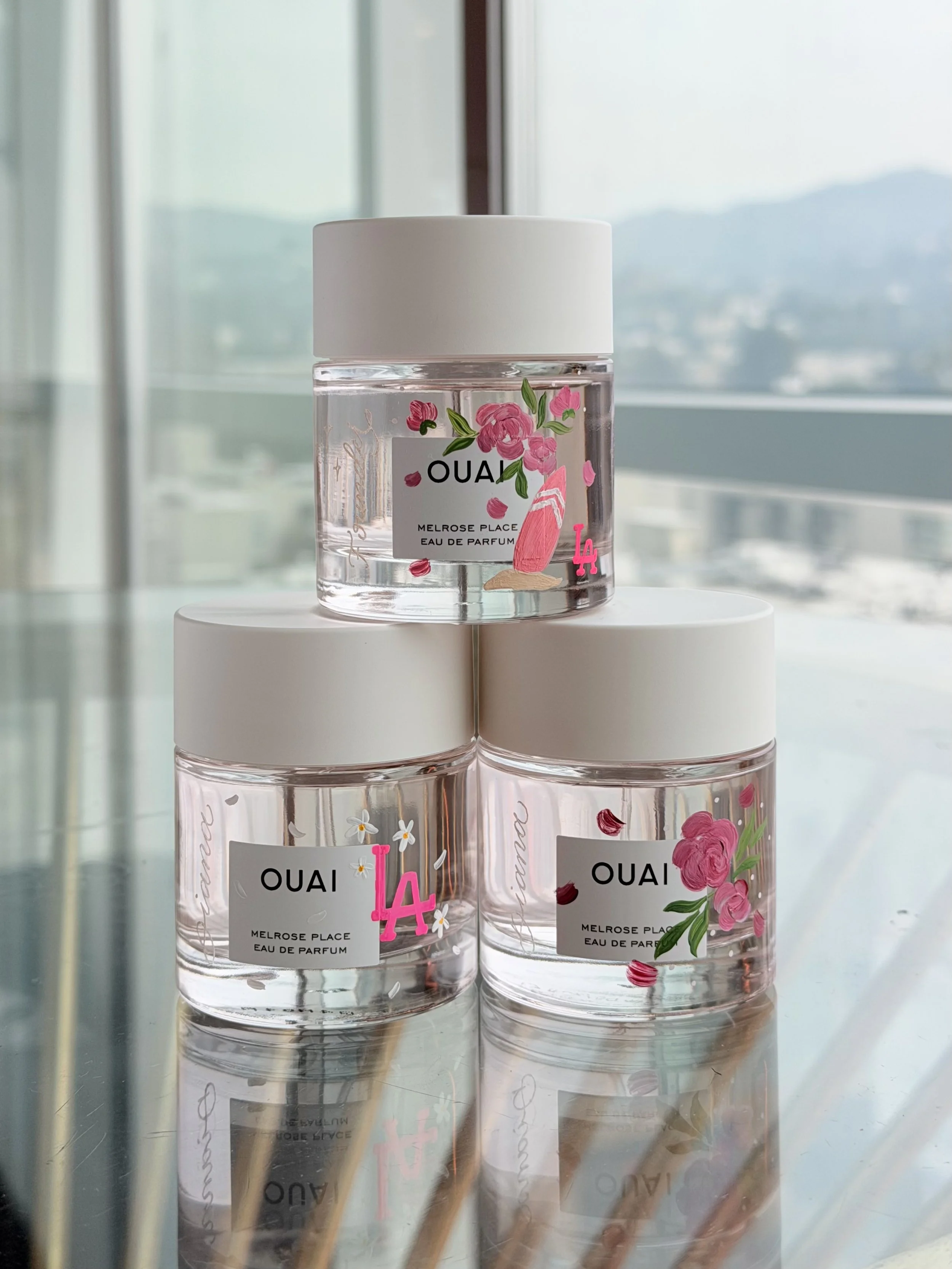 Live event bottle painting for OUAI in Los Angeles by ink and innuendos 