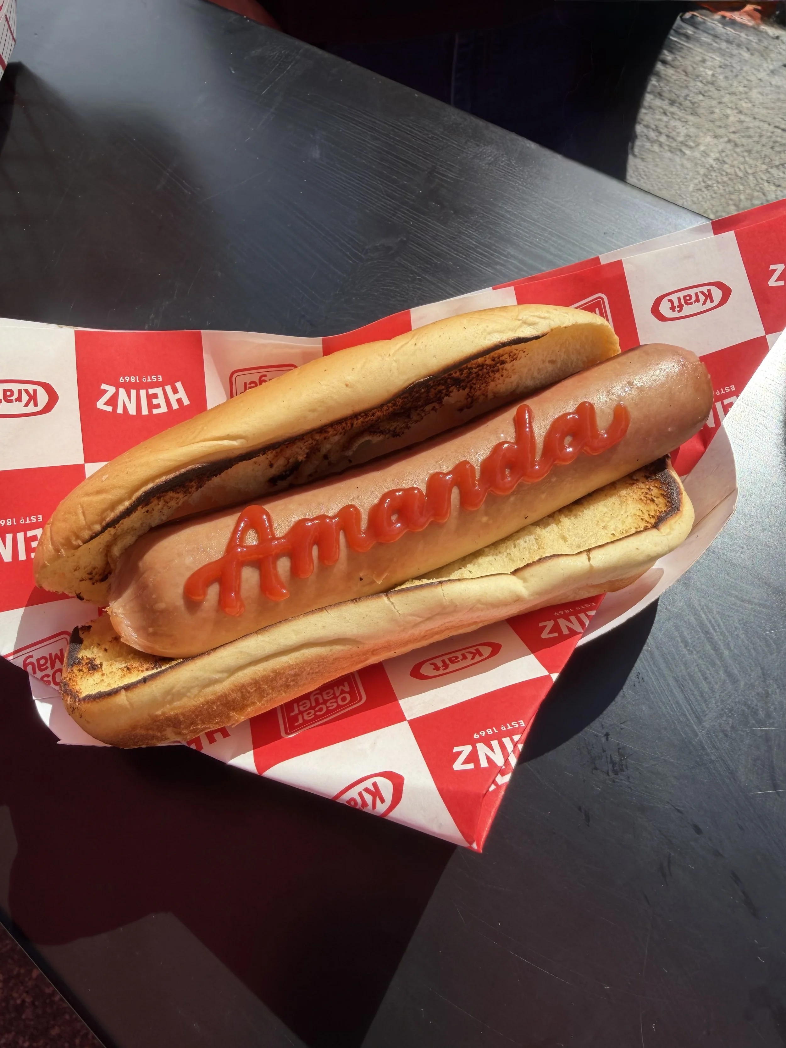 Live calligraphy on hot dogs and burgers for 4th of July America 250 event in Los Angeles by Ink and Innuendos