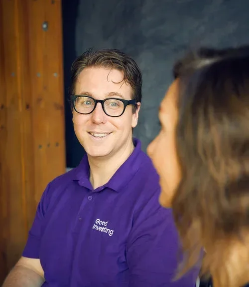 Man wearing glasses and purple shirt.