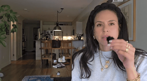 Woman looking frustrated and holding a mic.