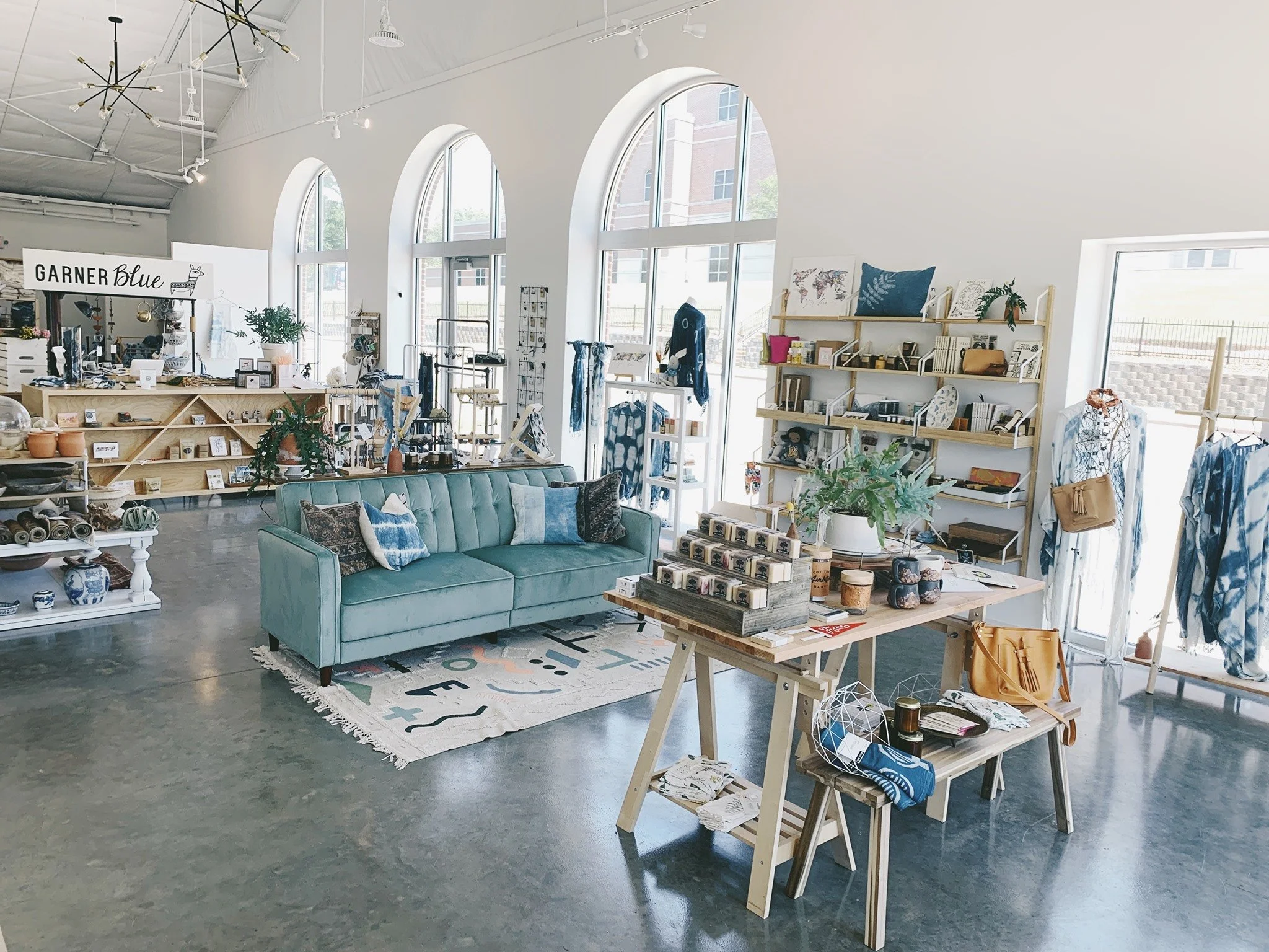 interior of Garner Blue Shop naturally well-lit with couch and merchandise