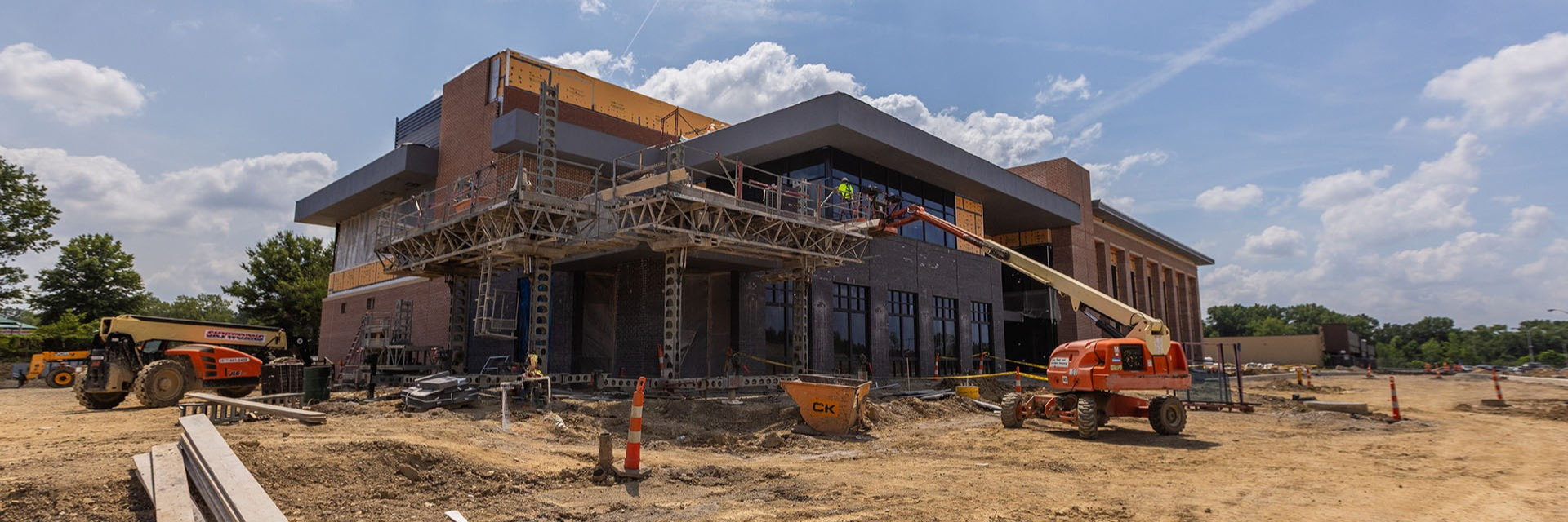 The Alliance National Office building under construction, with scaffolding, construction equipment, and works visible around the partially completed brick exterior.