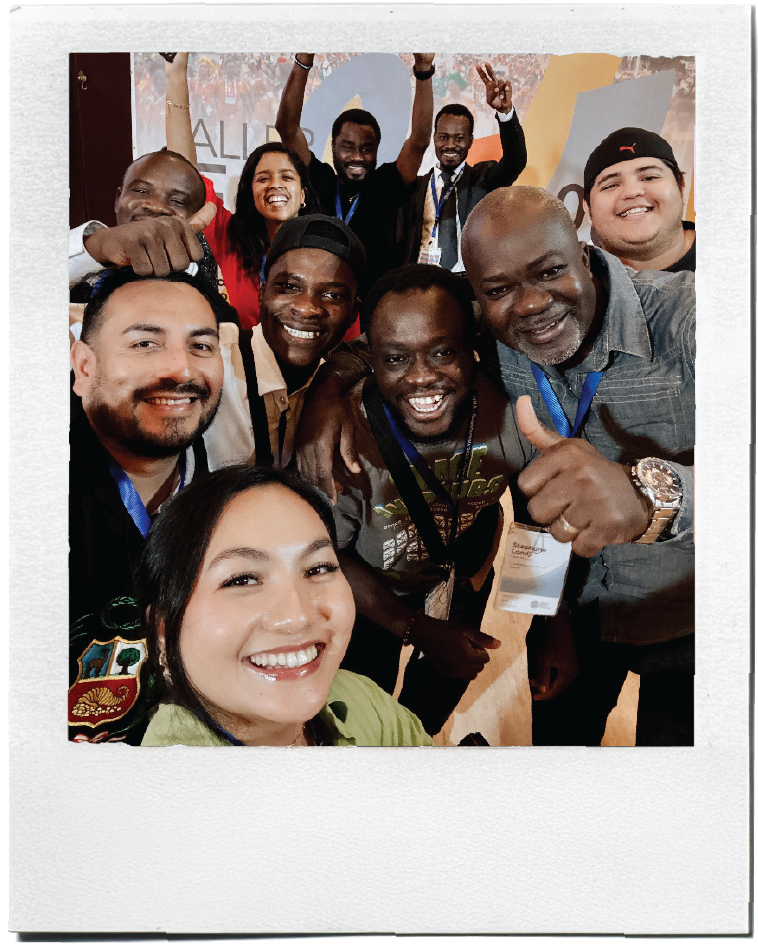 Polaroid-style photo of a diverse group posing together at an Alliance event.
