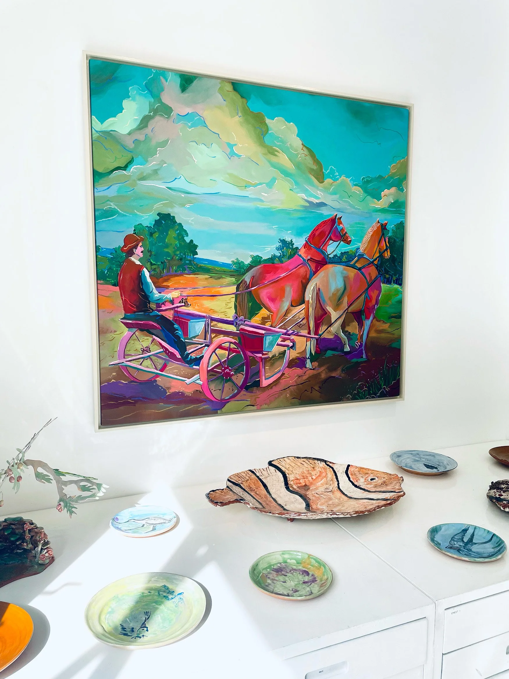 Colorful painting of a person in a horse-drawn carriage passing two horses on a rural landscape with a cloudy sky.