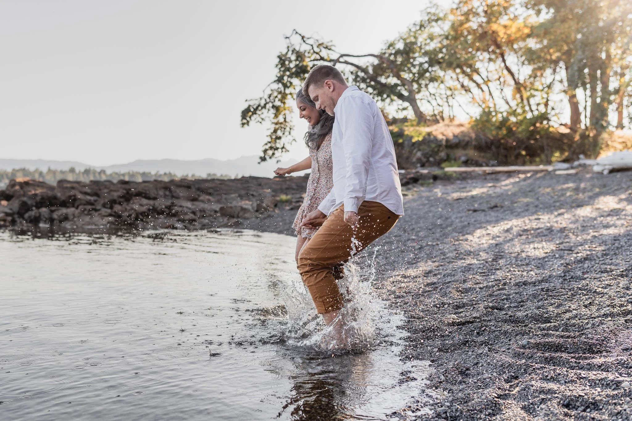 A playful family photo jumping in the ocean in Nanaimo