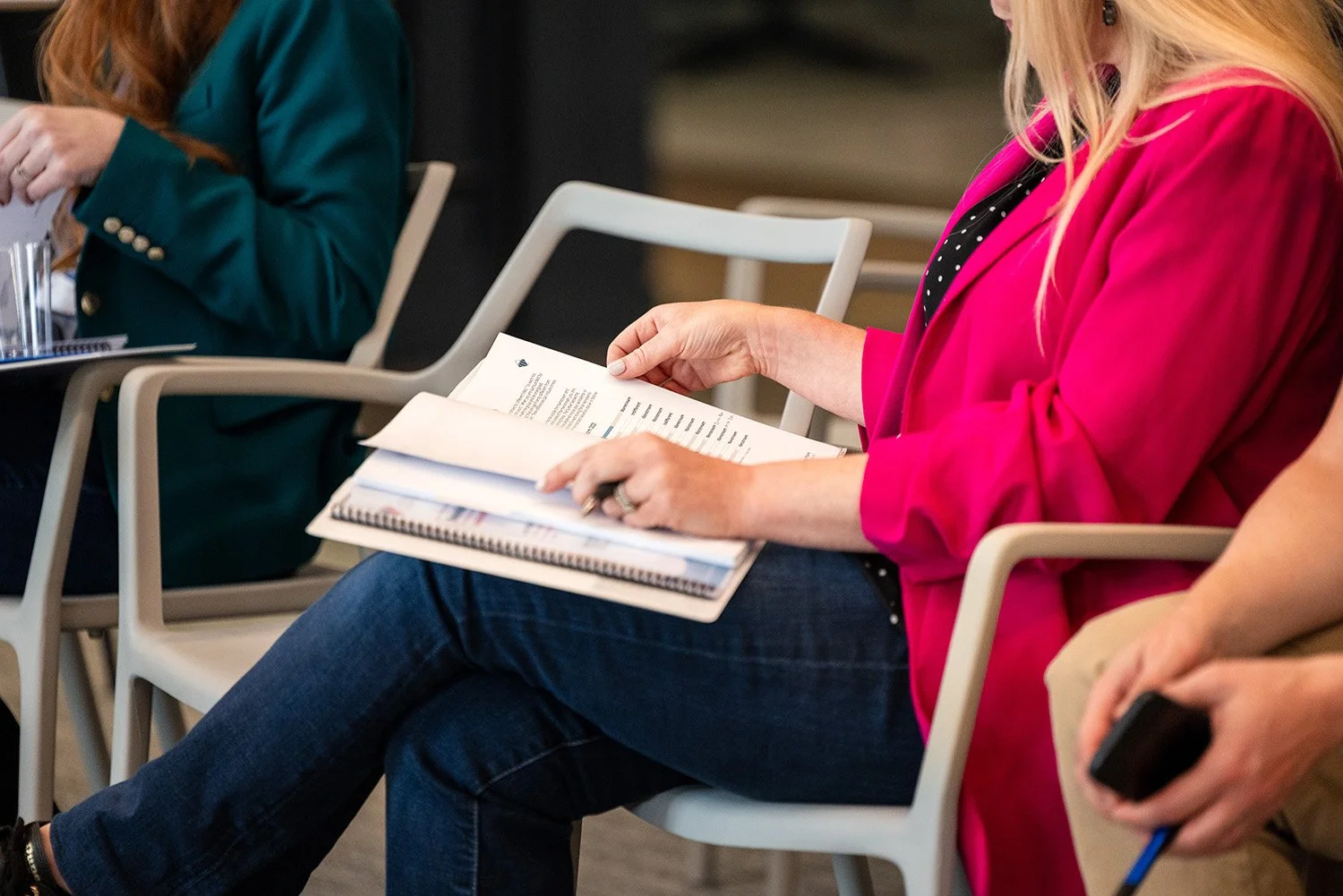 person reads pamphlet at corporate event summit in chicago