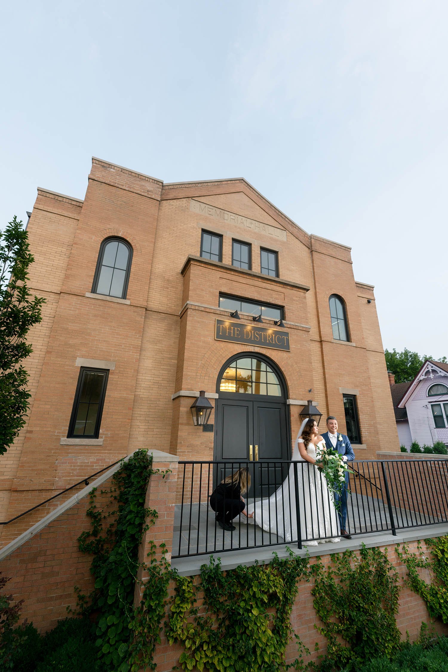 couple poses in front of The District in Richmond IL