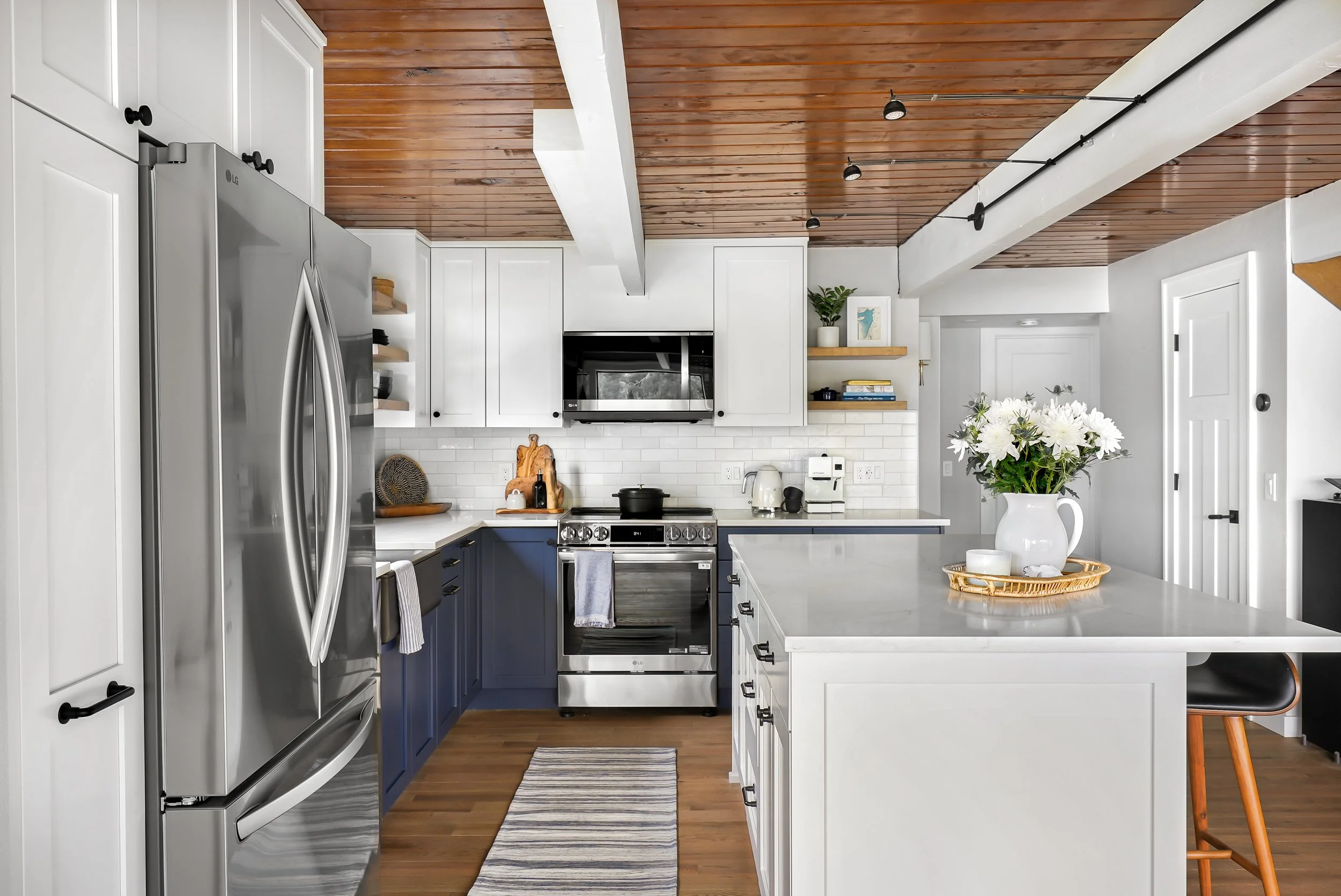 Stainless steel appliances and custom kitchen cabinetry in a University Place beach house remodel.