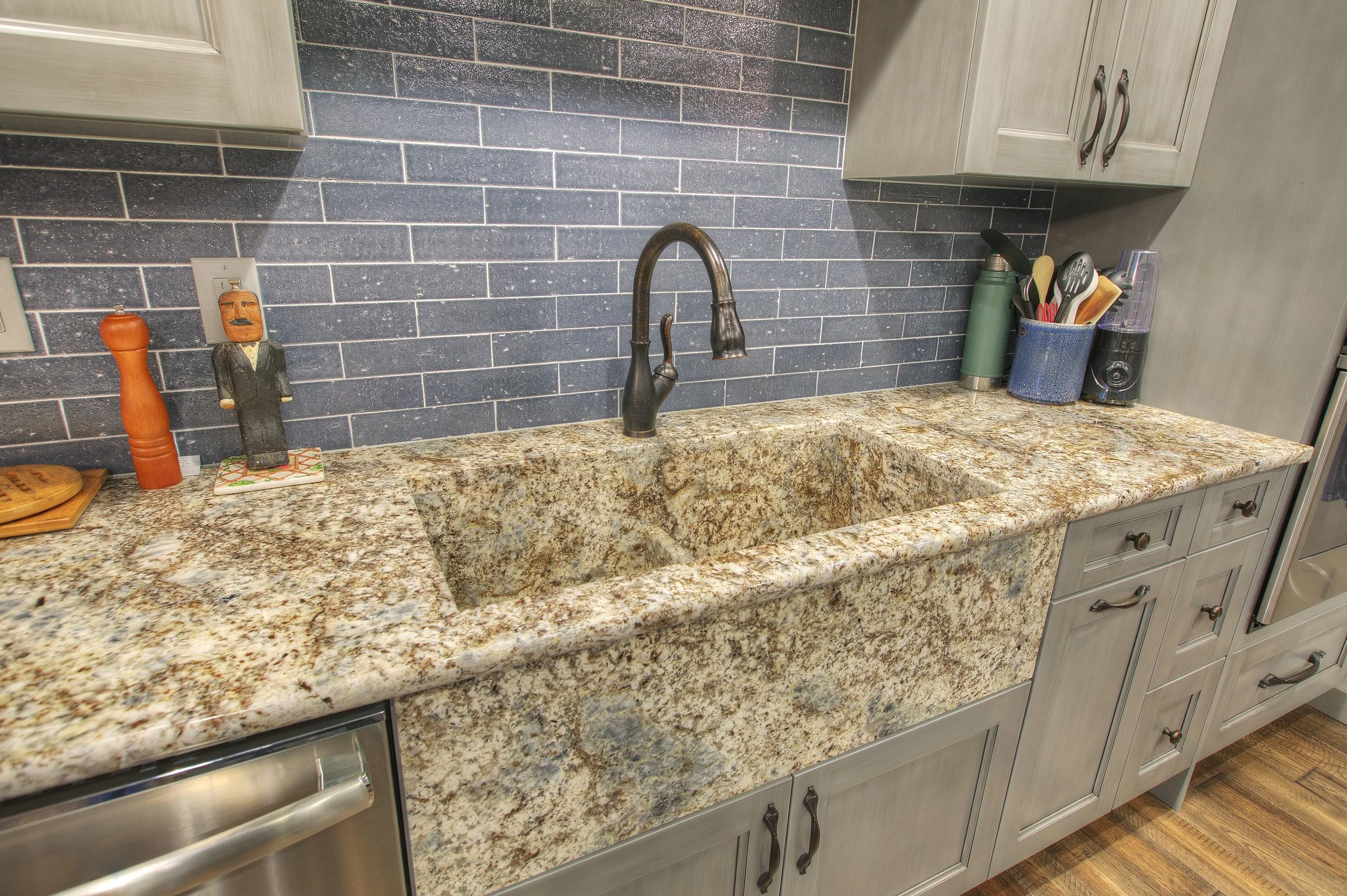 Undermount kitchen sink with a wood-trimmed window view in a Tacoma home remodel.