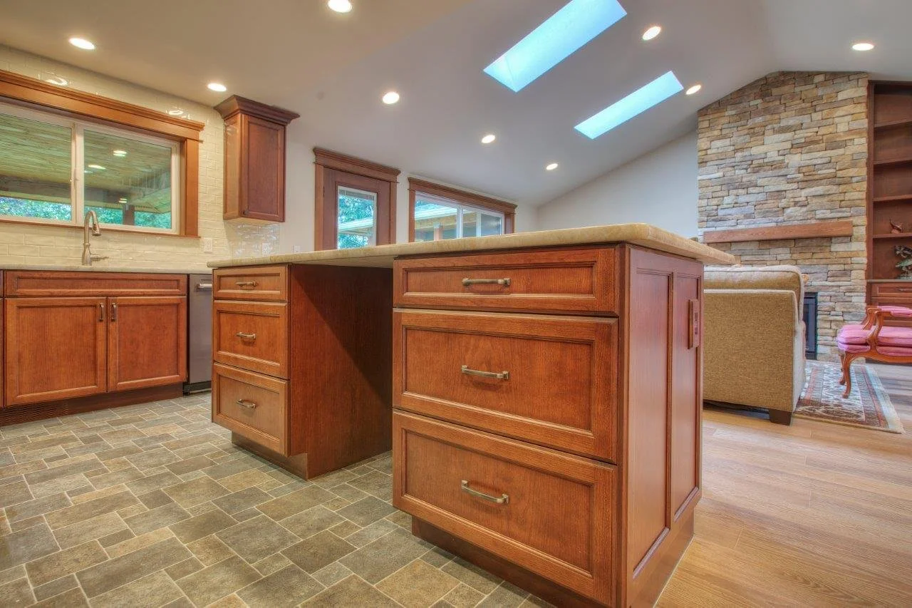 Craftsman-style kitchen remodel in Pierce County with a large wood island and skylights.