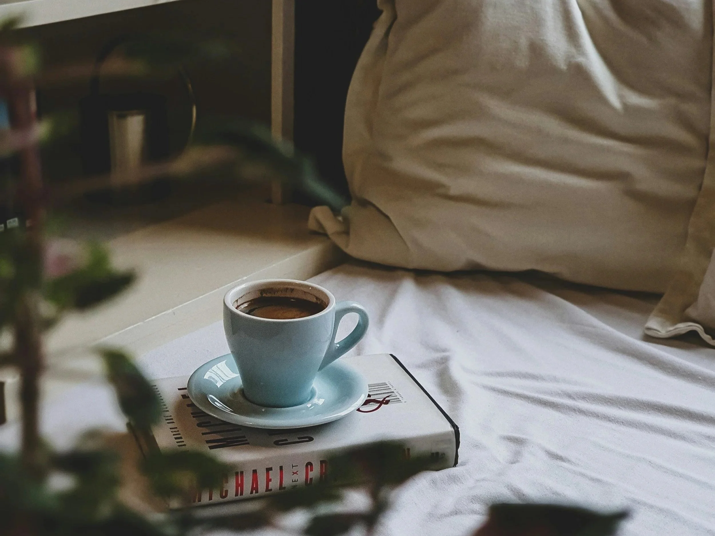 coffee on books in bed