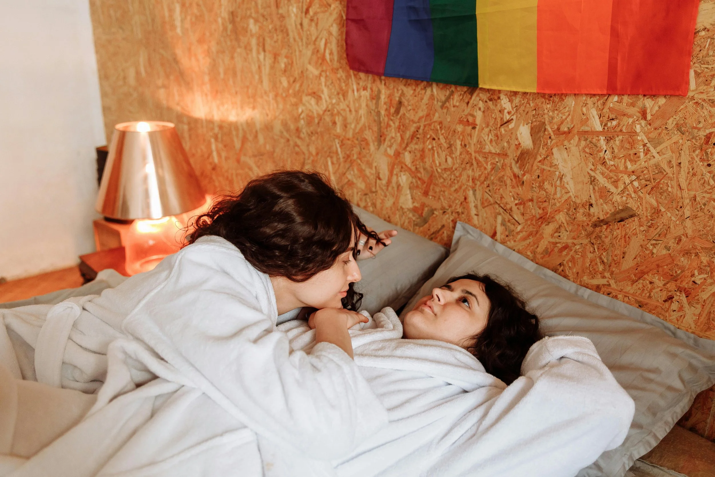 queer couple in bed feeling distant