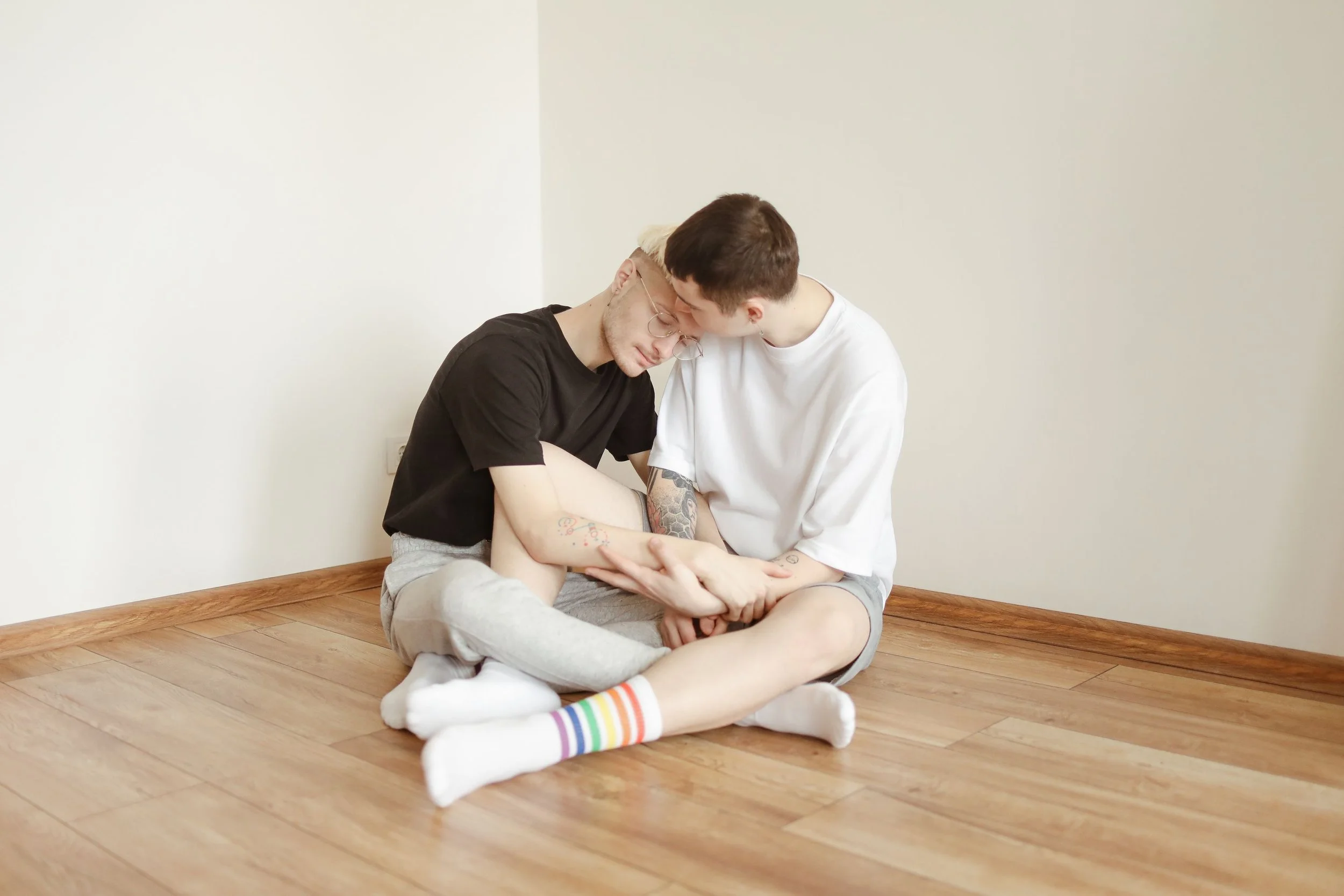 two lgbtq people looking sad