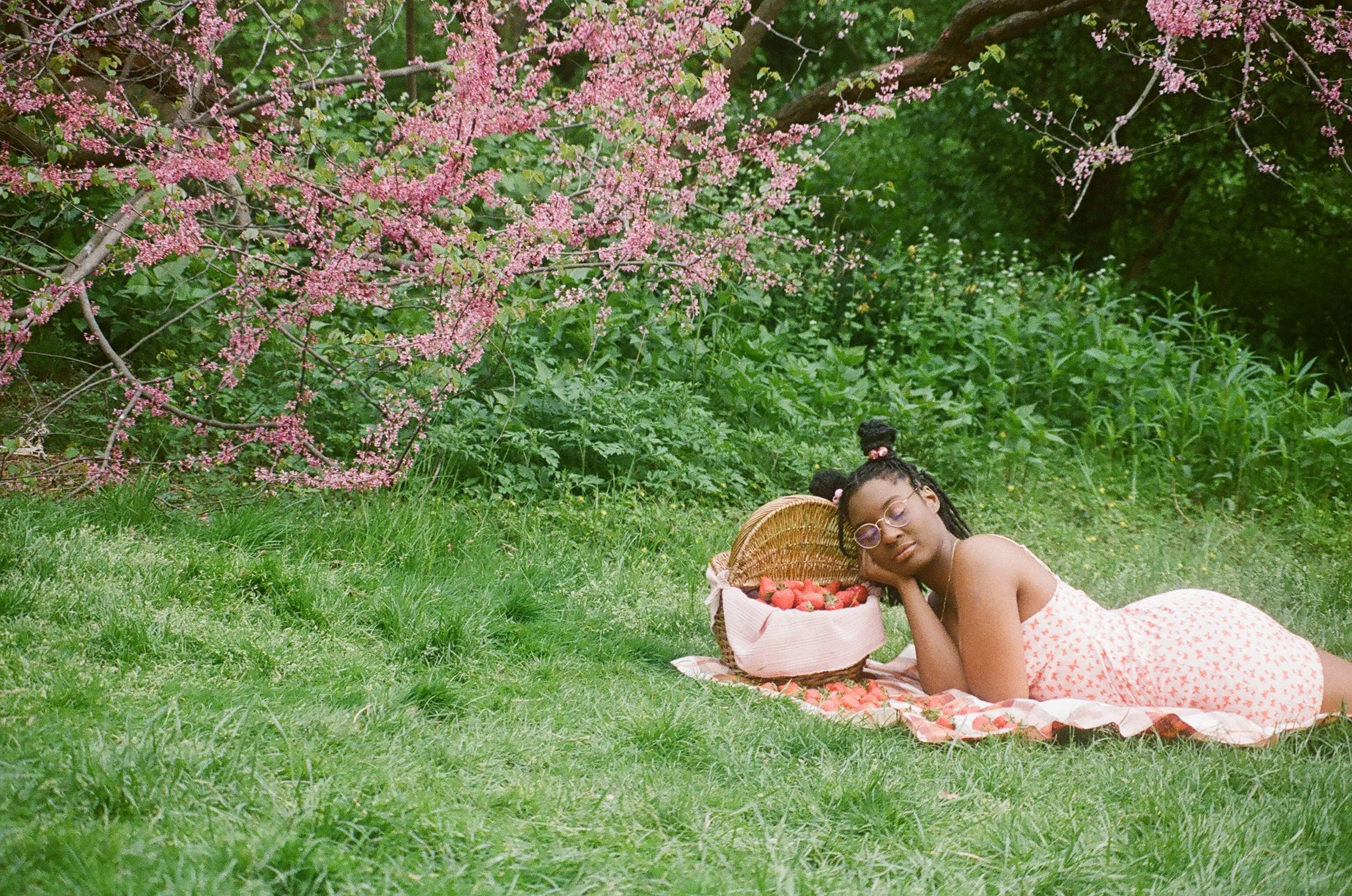 woman lying in field with picnic basket