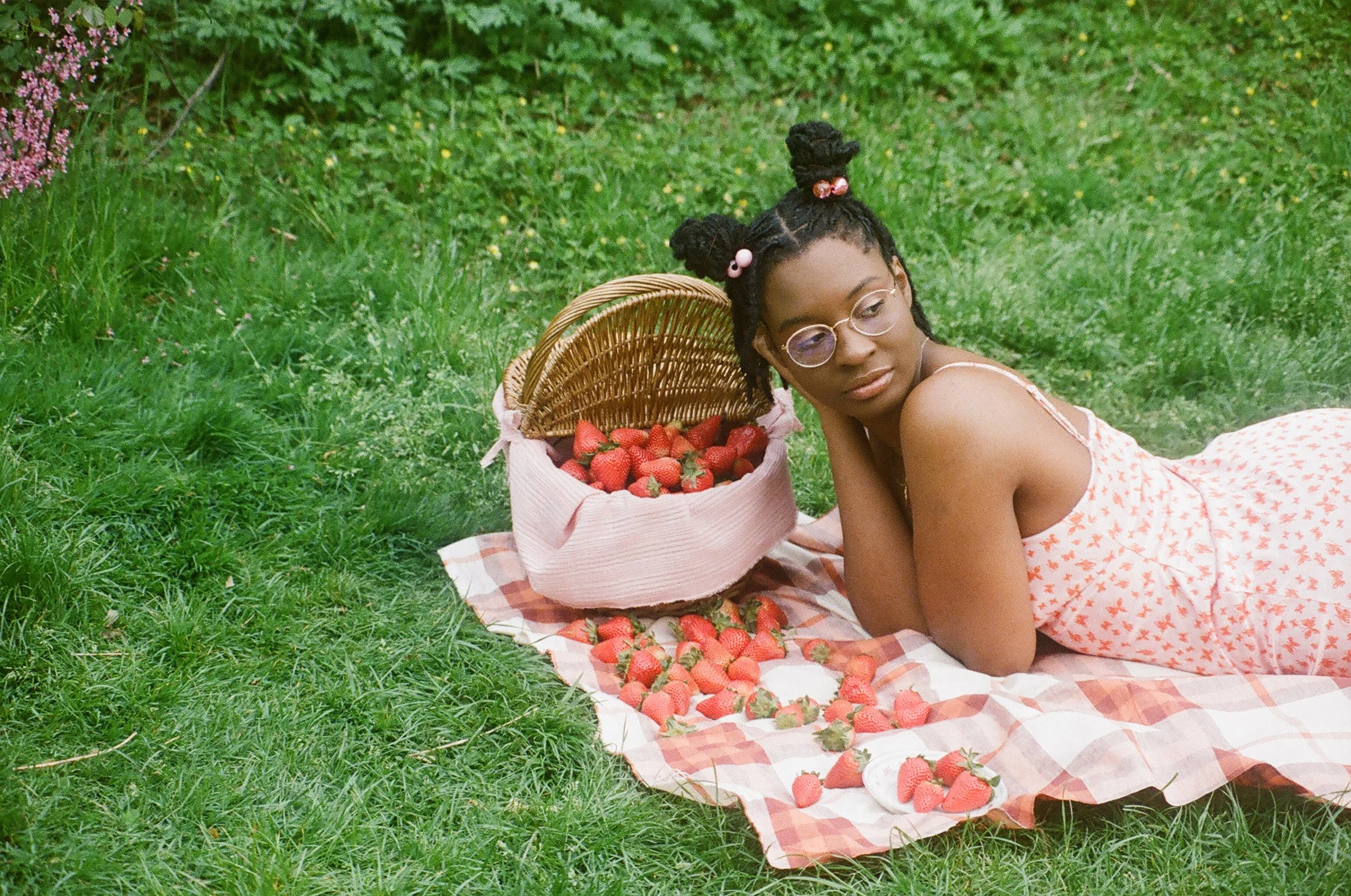woman with picnic basket filled with strawberries