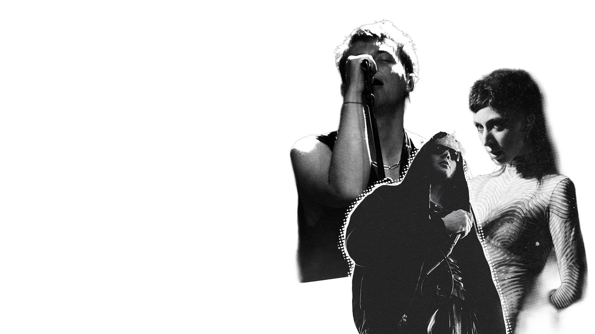 Black and white photo of three people, with one singing into a microphone and the others listening closely, against a black background.