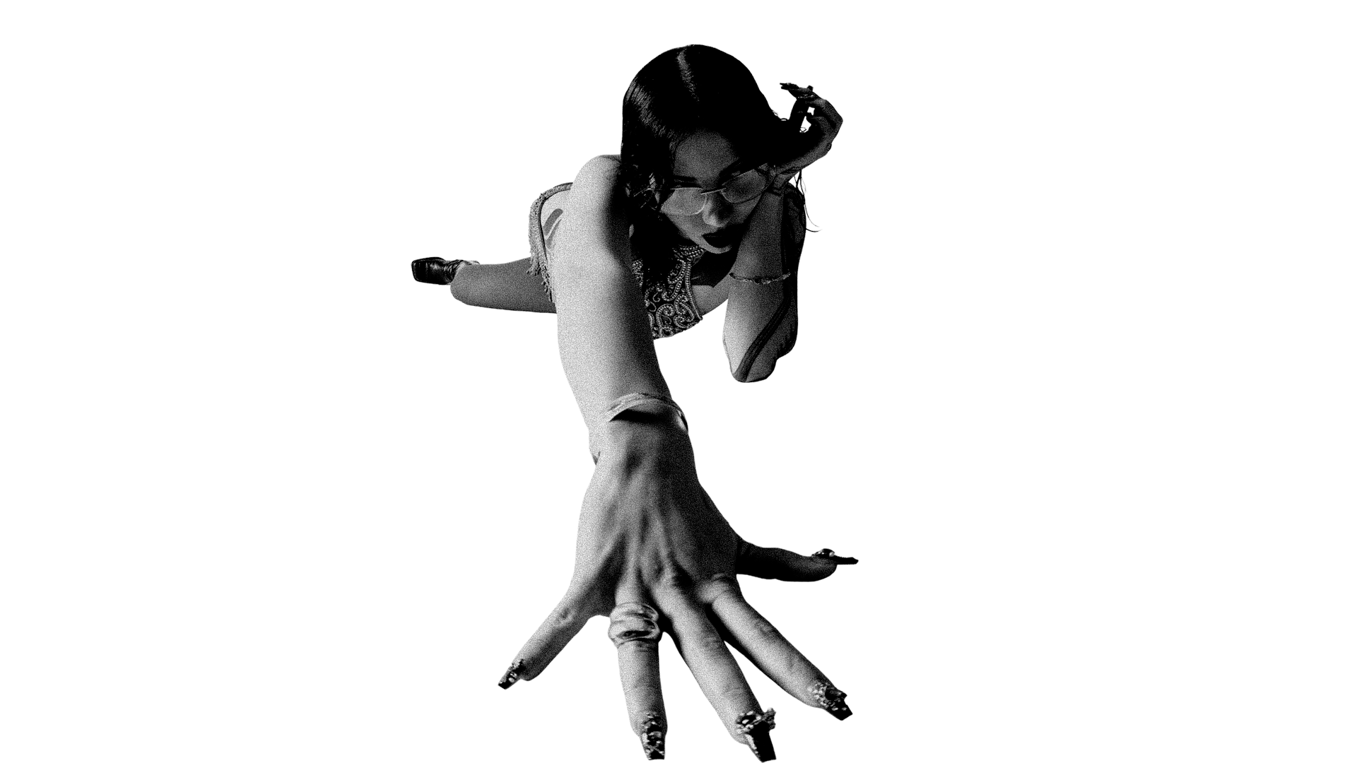 A woman with glasses and dark hair, dressed casually, is crawling on the ground with her hand extended towards the camera, set against a dark background.