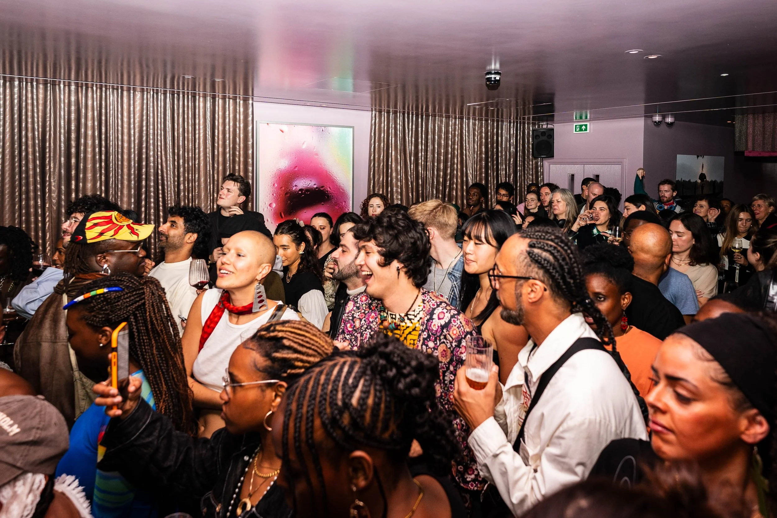 Dense crowd of visitors gathered inside a hotel space during Minor   Attractions, highlighting the fair's social, open-access energy