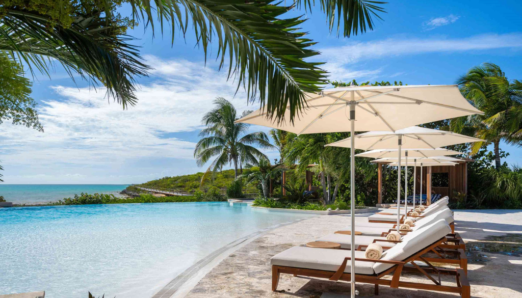 Calico pool at Ambergris Cay all-inclusive luxury resort in Turks and Caicos with crystal-clear Caribbean water and tropical garden surroundings