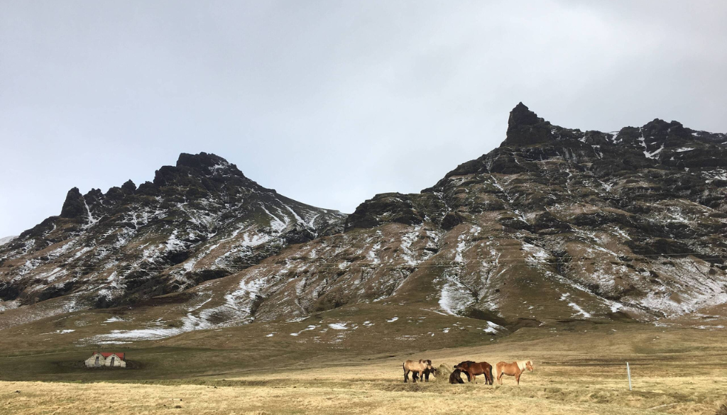 Dramatic Iceland landscape with volcanic mountains, and moody overcast skies — honeymoon in Iceland