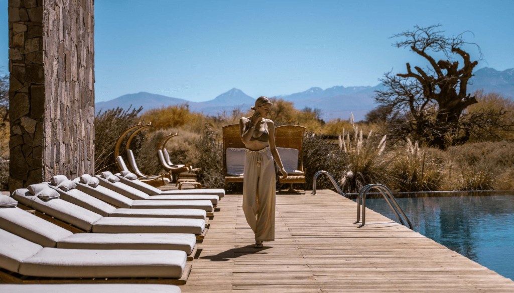 Poolside at Tierra Atacama hotel and spa in San Pedro de Atacama Chile with the Licancabur volcano on the horizon and desert landscape surrounding the resort