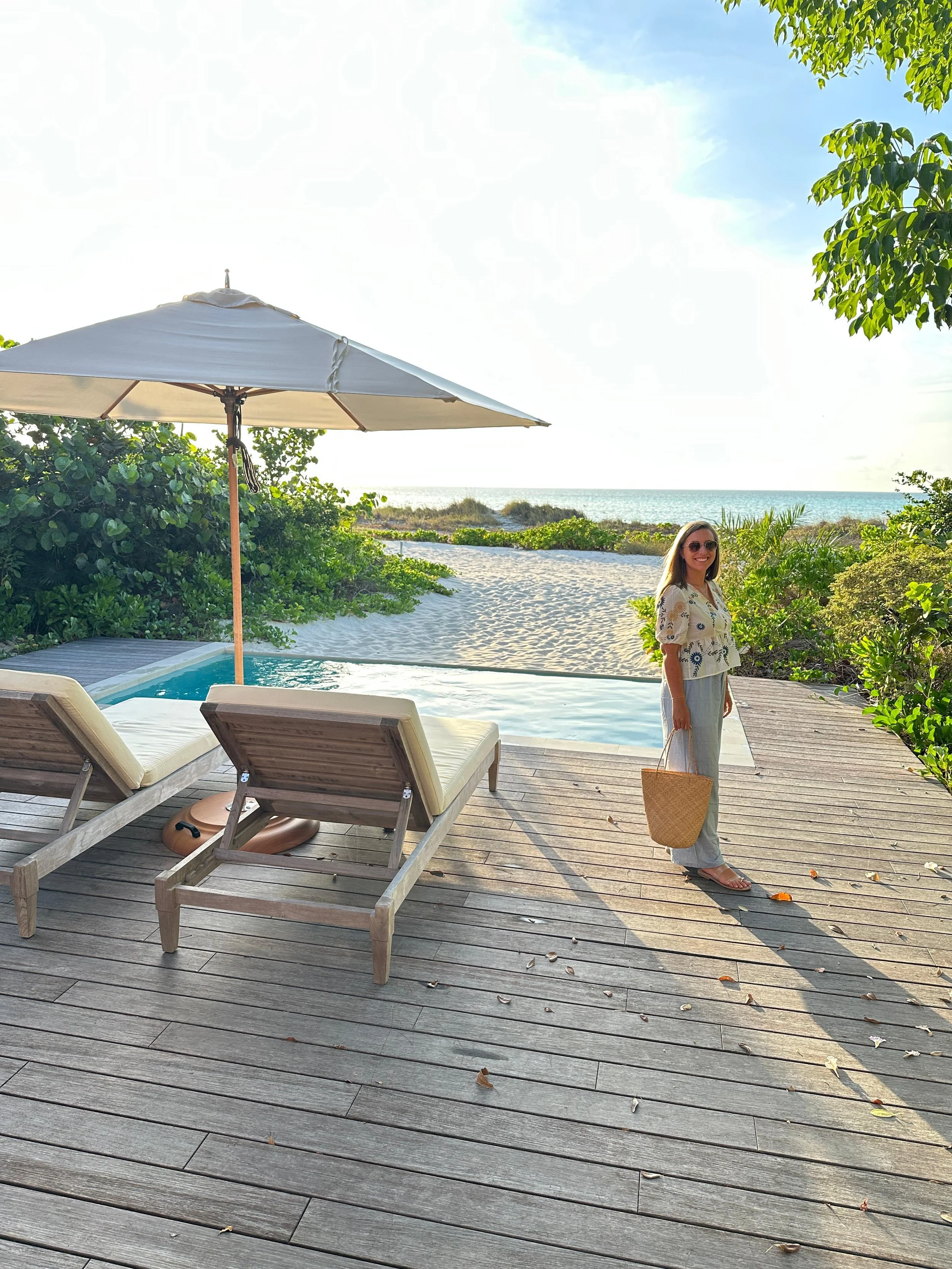 Pristine beachfront at COMO Parrot Cay private island resort in Turks and Caicos with white sand, turquoise sea, and tropical palms