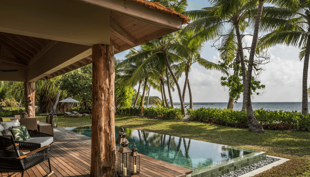 Four Seasons Resort Seychelles at Desroches Island with barefoot luxury beachfront villa, swaying coconut palms, and private lagoon on a remote Amirante island