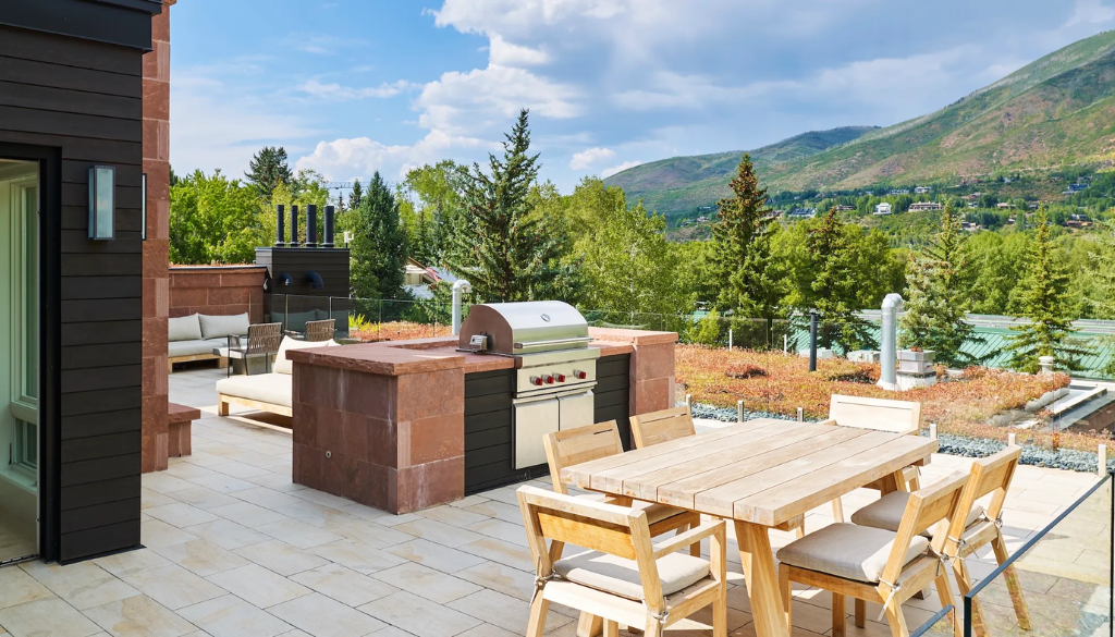 Close detail of the historic red brick exterior and white Victorian entrance trim at Hotel Jerome in Aspen