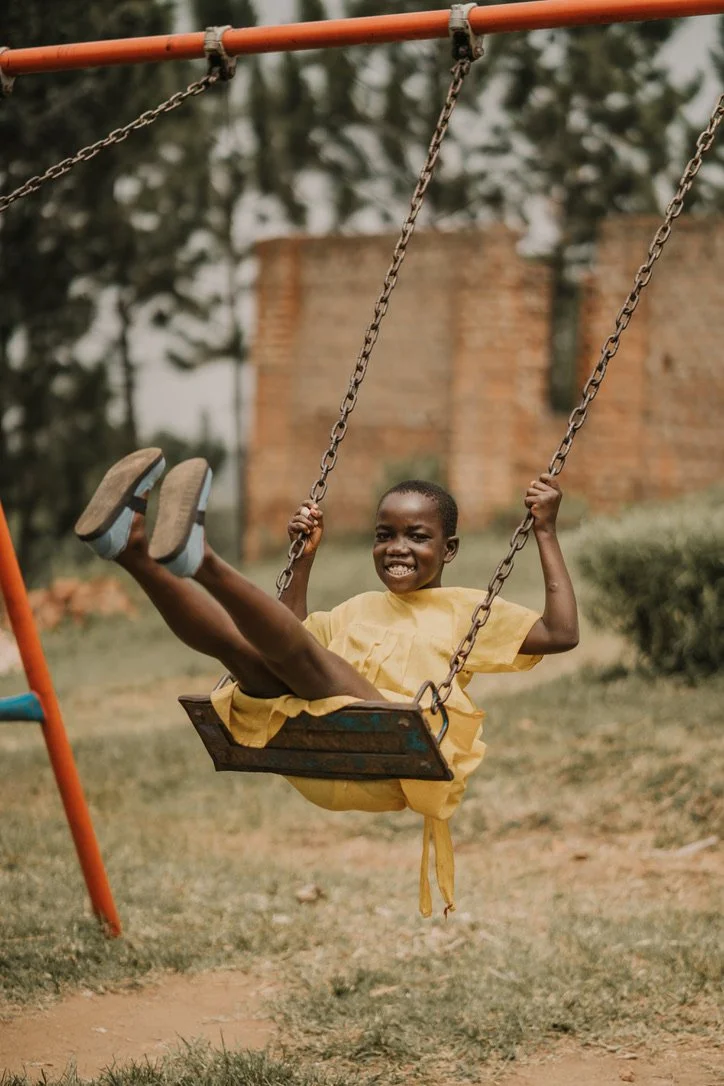 Girls walking together in Uganda wearing Sole Hope shoes