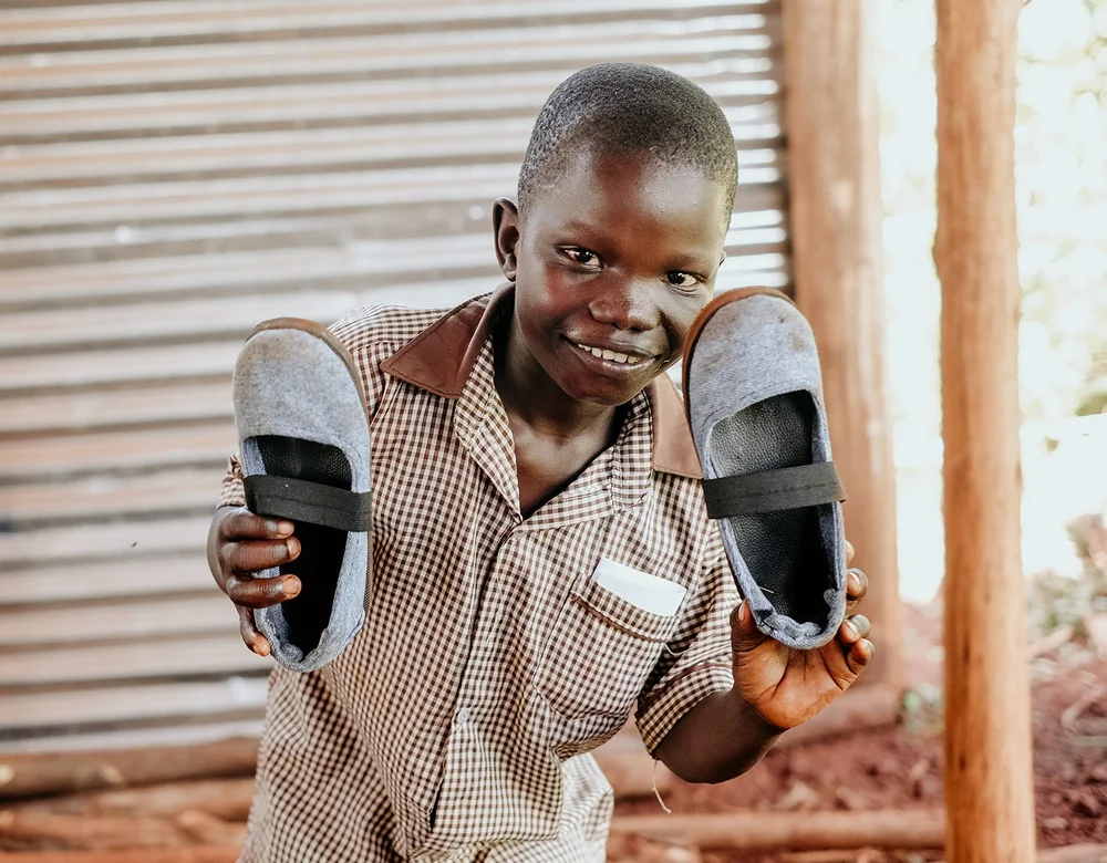 Child in Uganda smiling after receiving care
