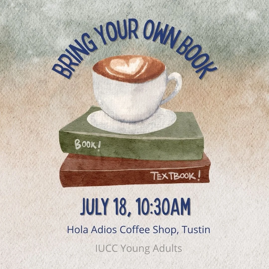 A teacup with coffee and a cream heart atop a stack of two books