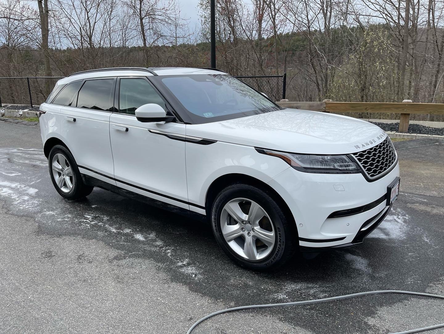 White SUV parked outdoors, front side view
