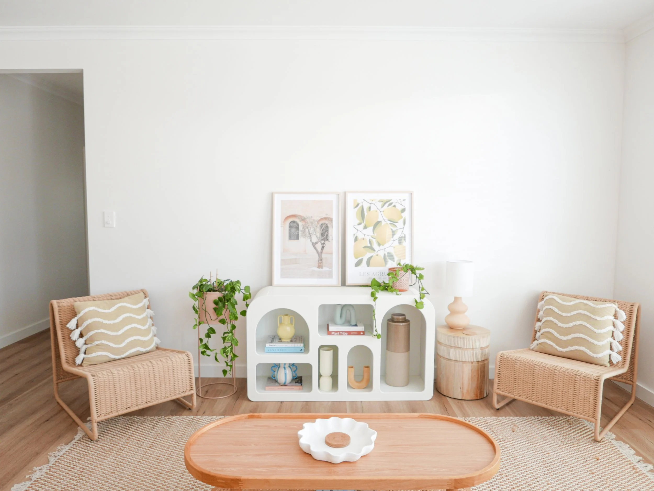 neutral-living-room-vignette-arched-shelf-botanical-prints-timber-coffee-table.