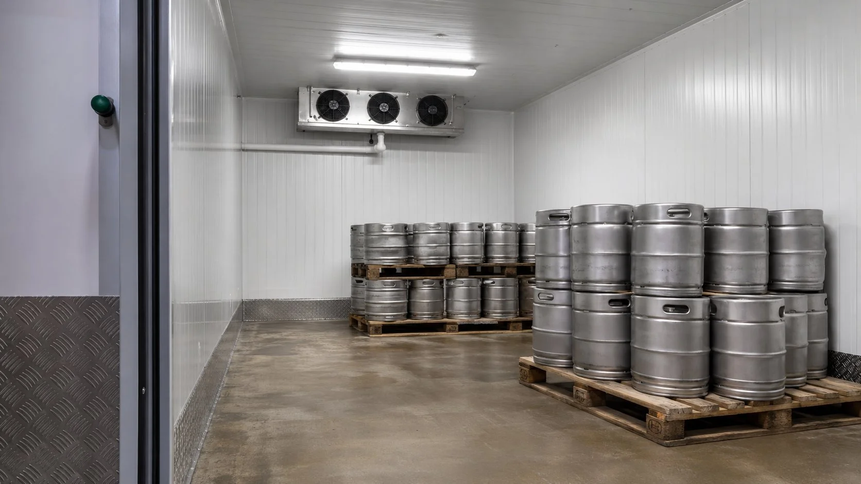 Cold room stacked with beer kegs at a craft brewery