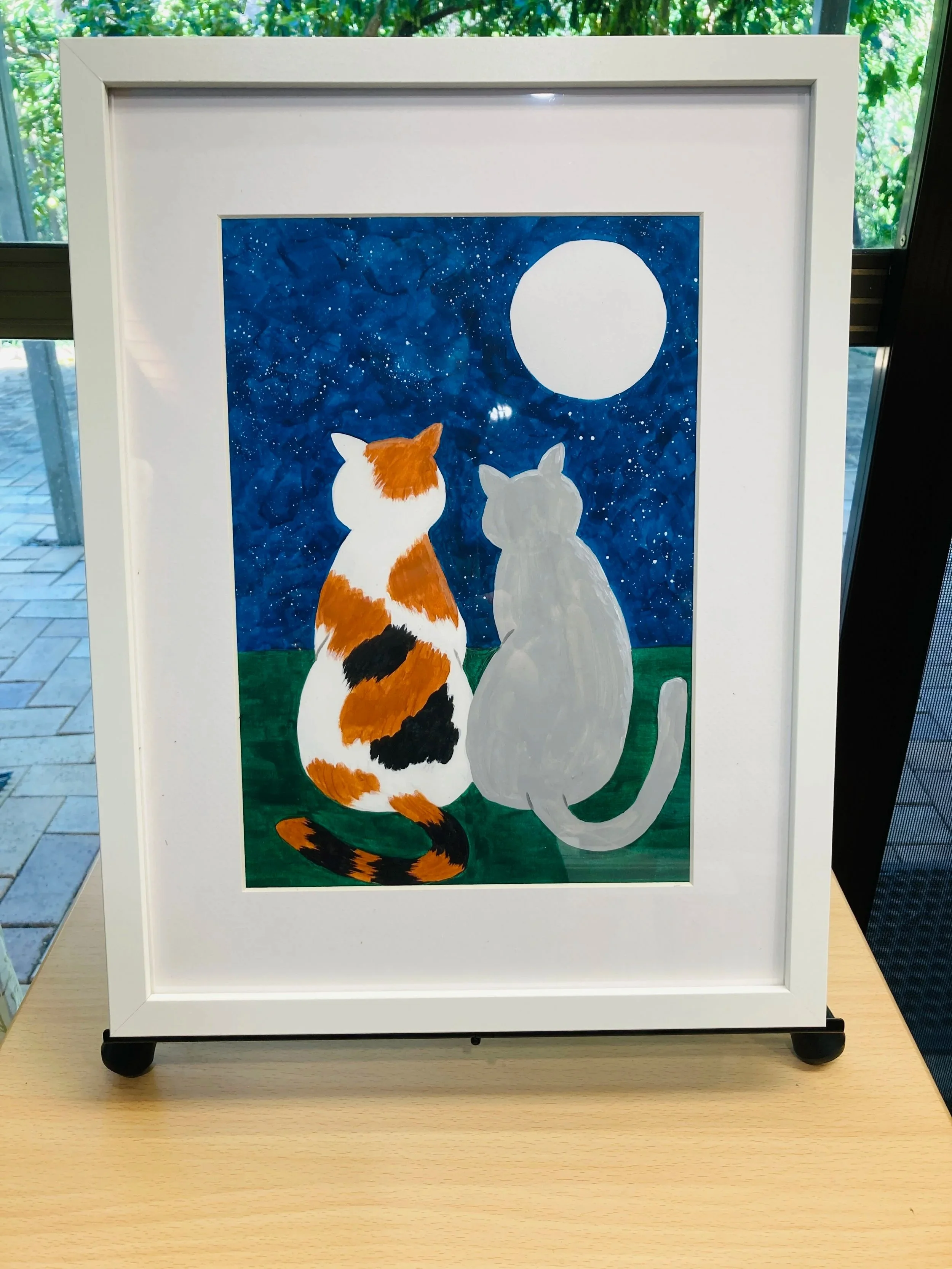 Image of Moonlight Cats painting in a white frame with a white mat