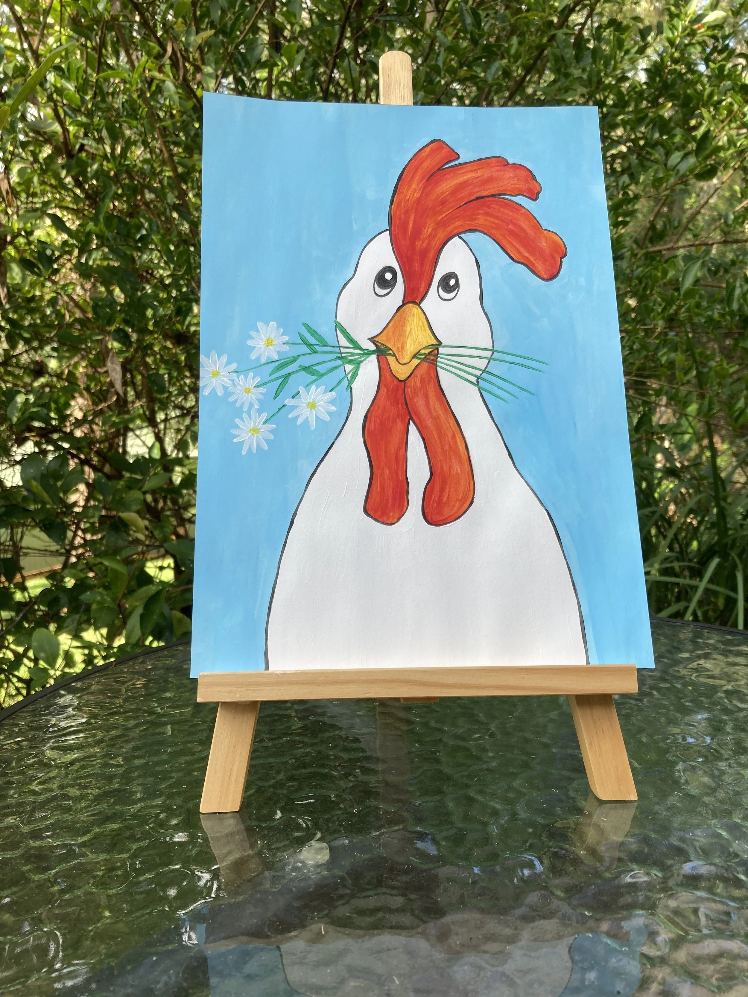Chicken with Daisies painting on easel.JPG