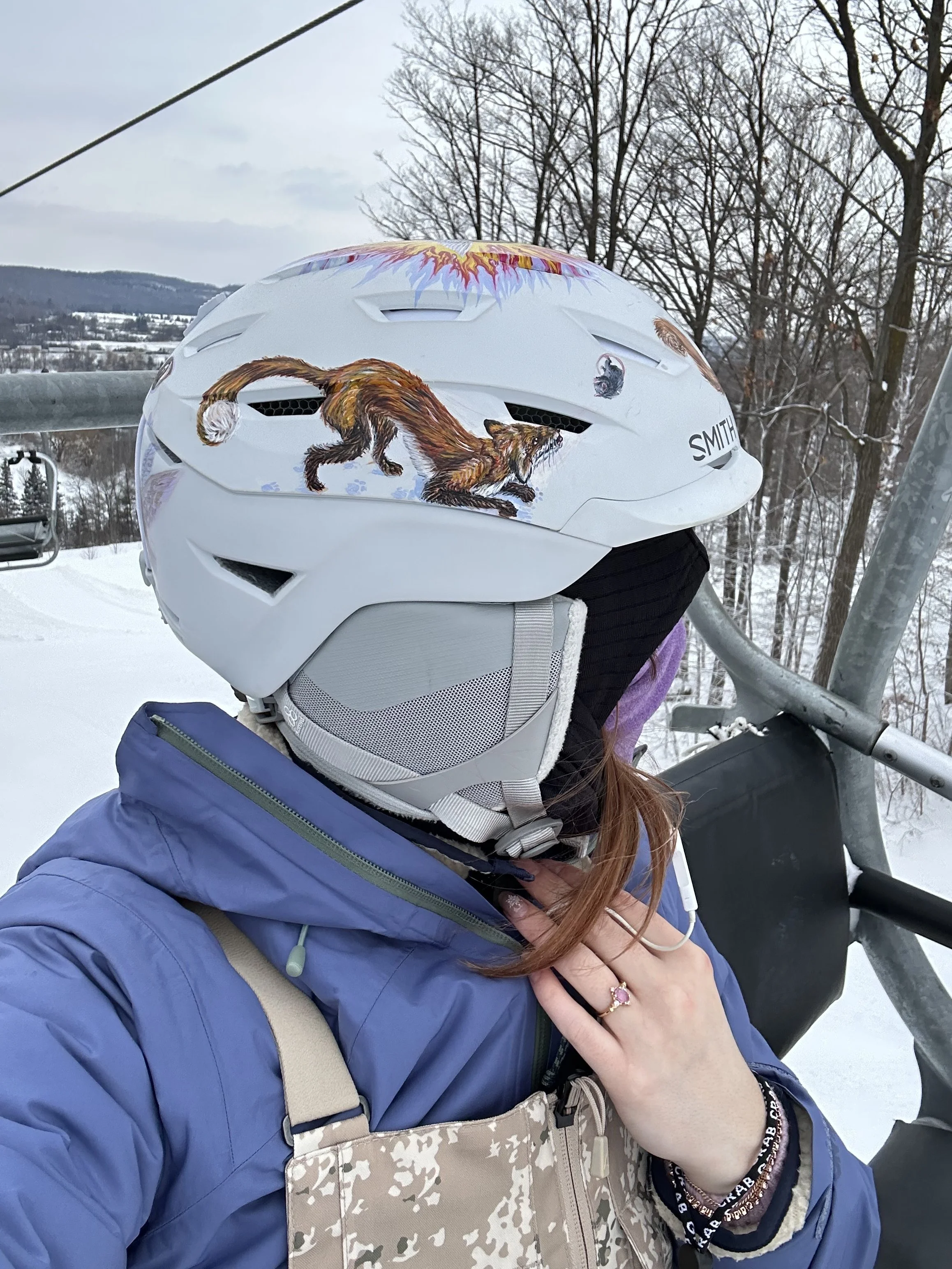 Helmet Project:  side fox catching rat detail (2026). Acrylic on ski helmet. 