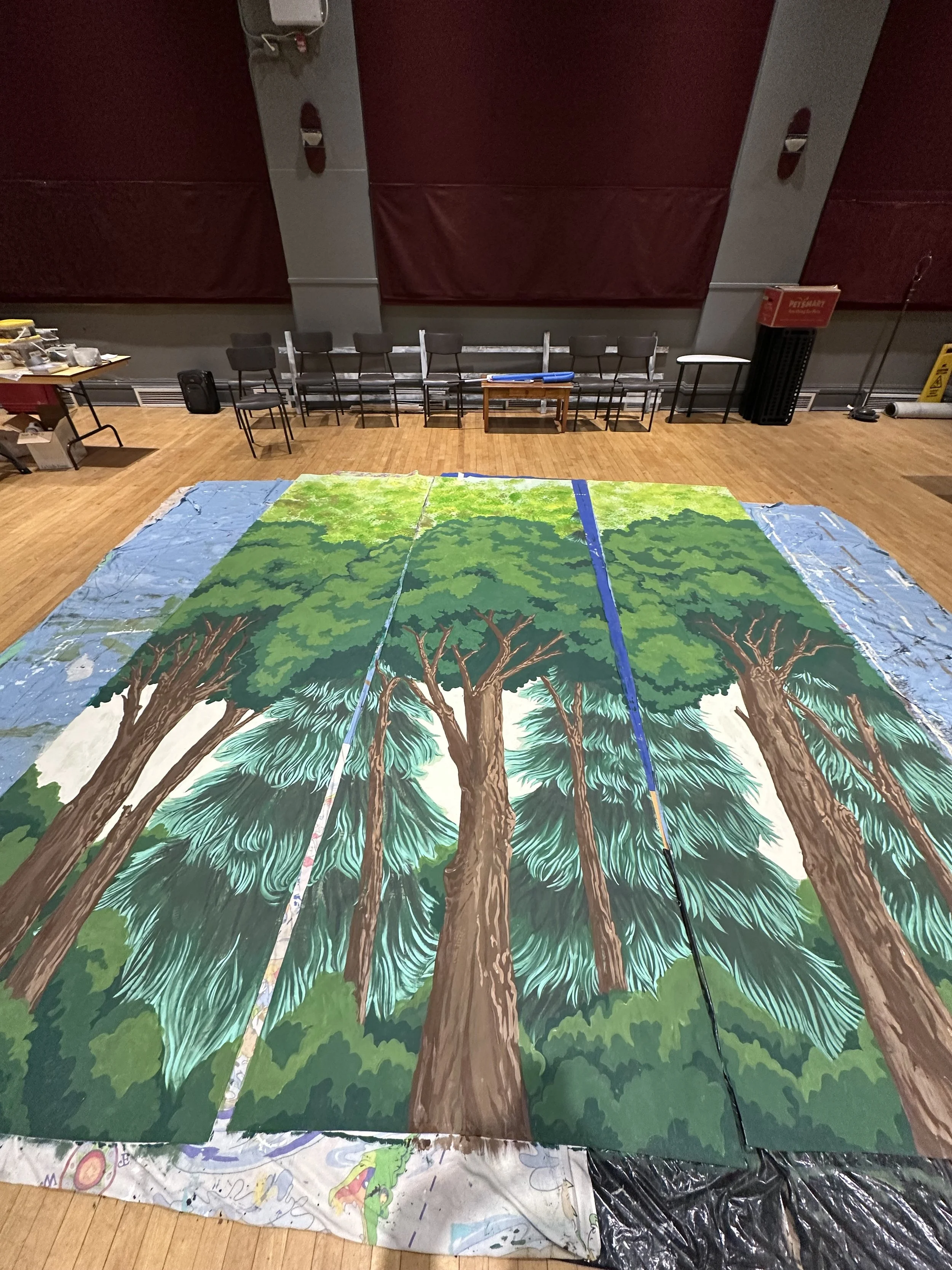 Village Theatre Backdrop (2026). 4 x 13 ft. (3 panels). Acrylic matte paint on donated material.