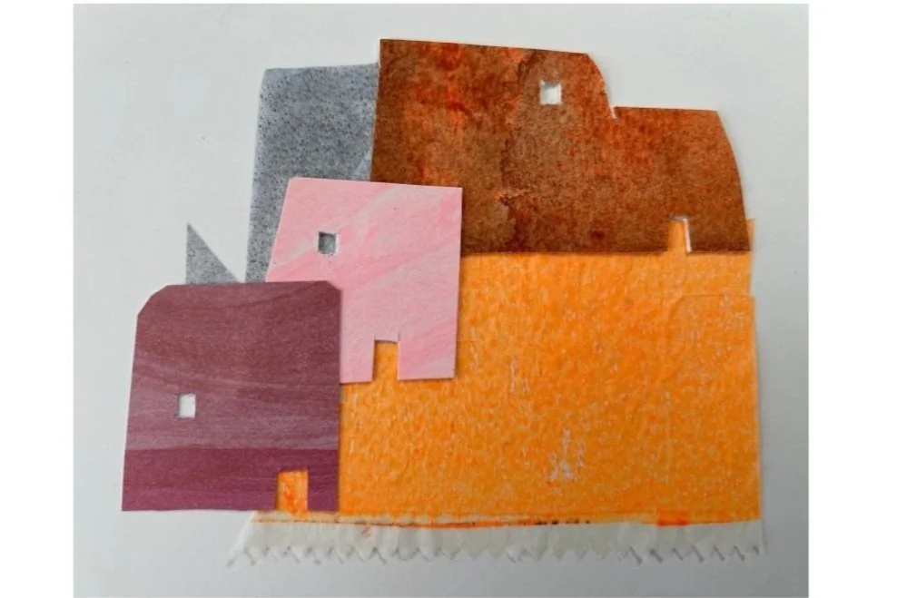Colorful paper house cutouts in pink, orange, brown, gray, and purple layers, arranged on white background.