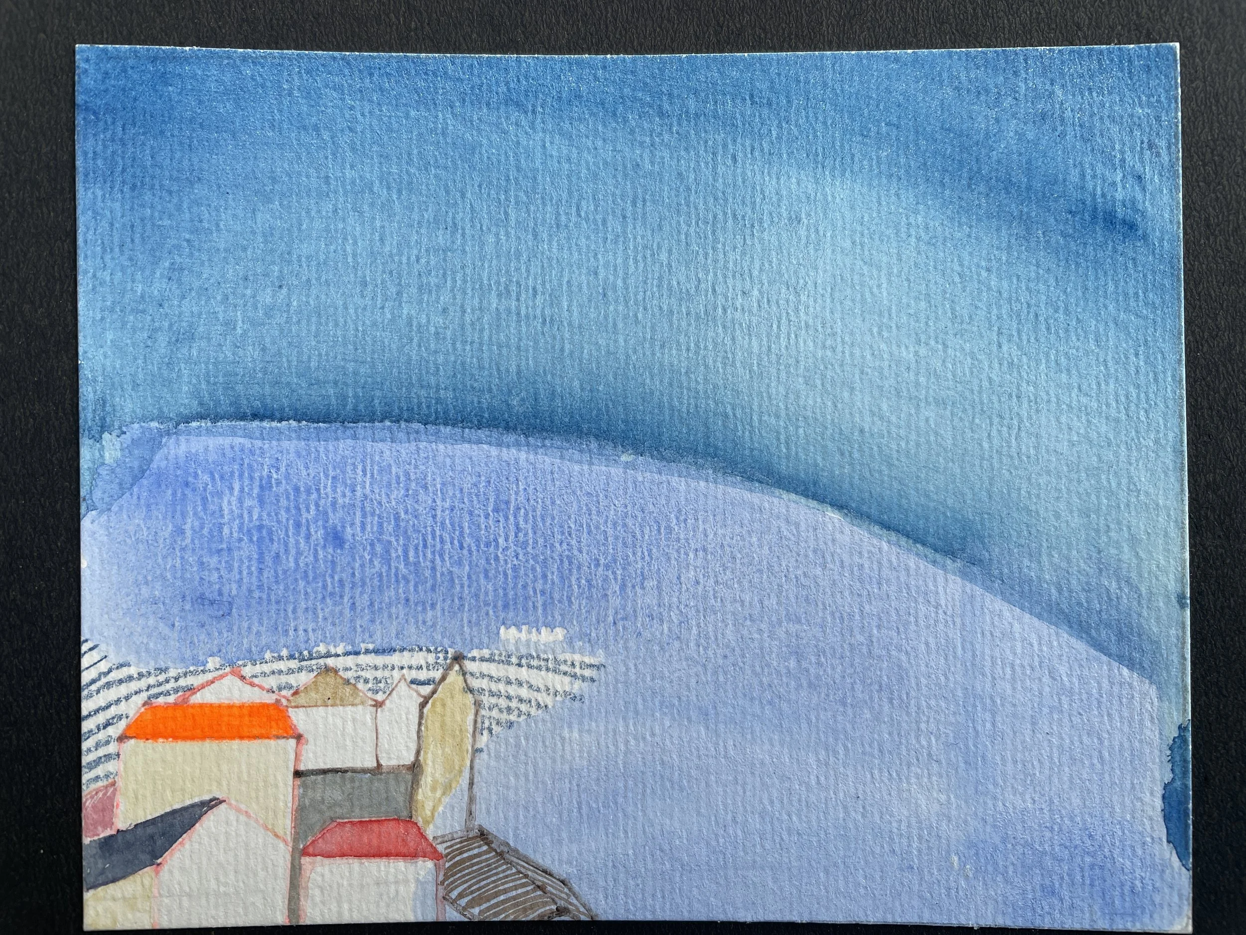 Watercolor painting of houses in front of a blue sky and distant mountains.