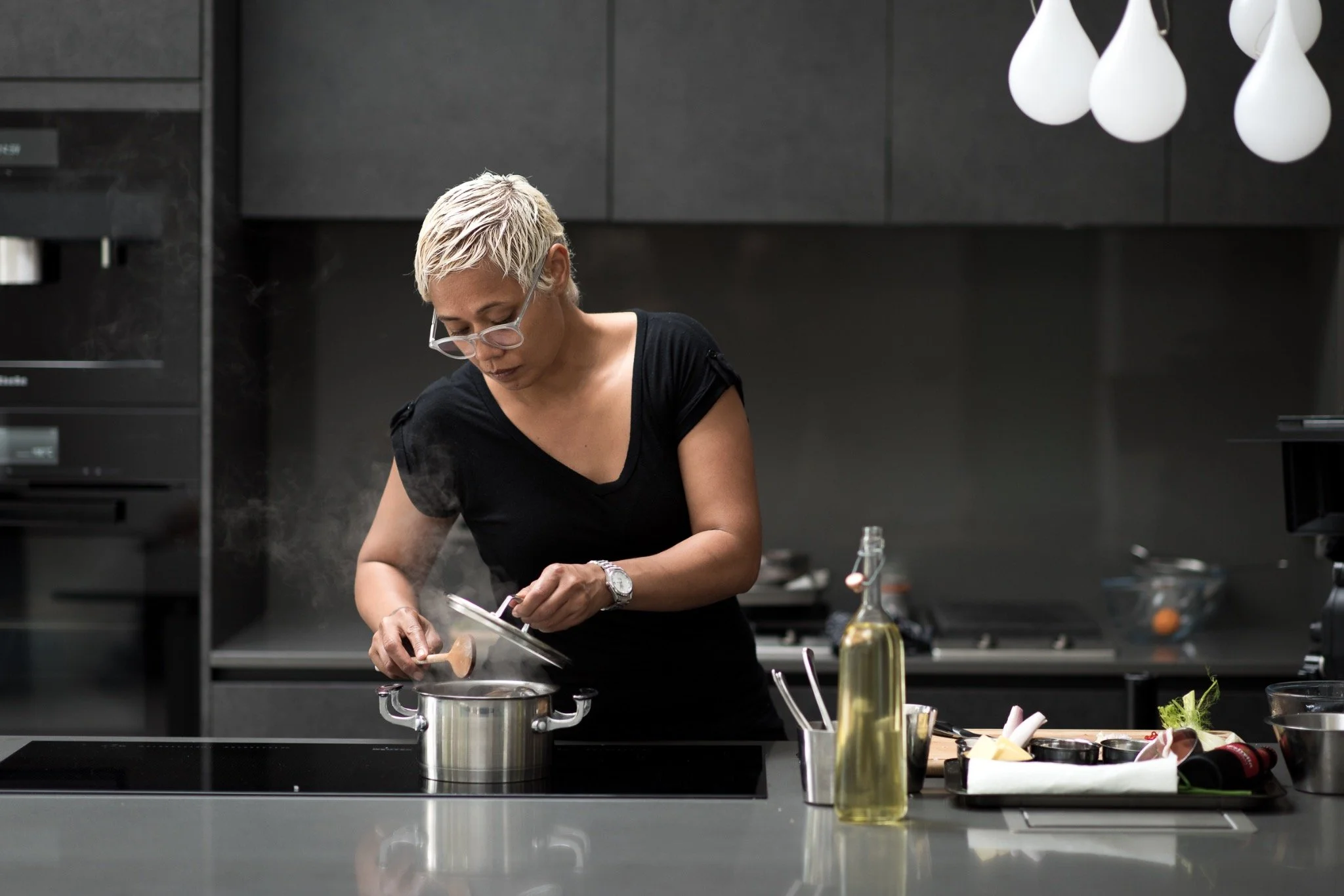Monica Galetti stirring a pan in her kitchen