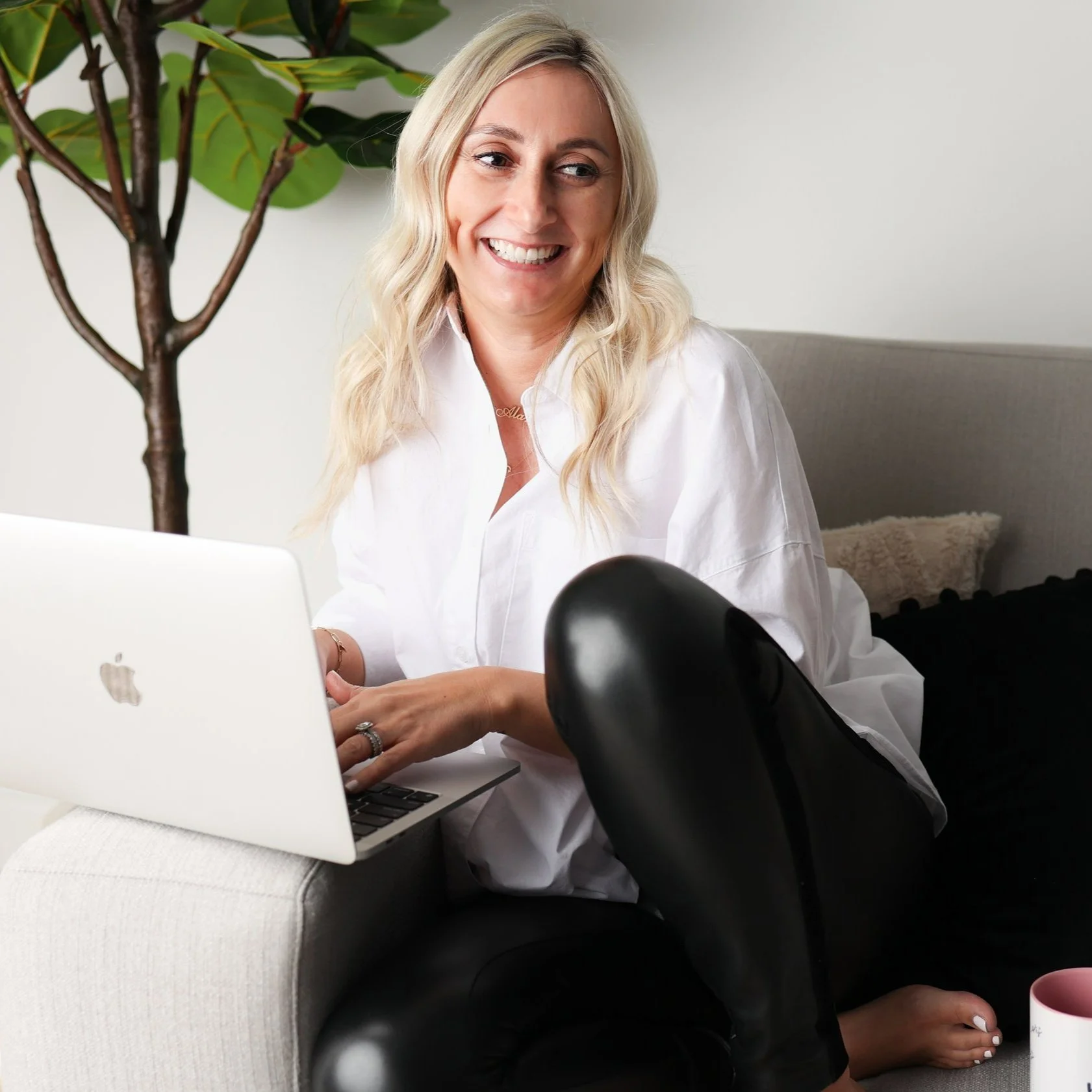 Alana Metallo on laptop helping families