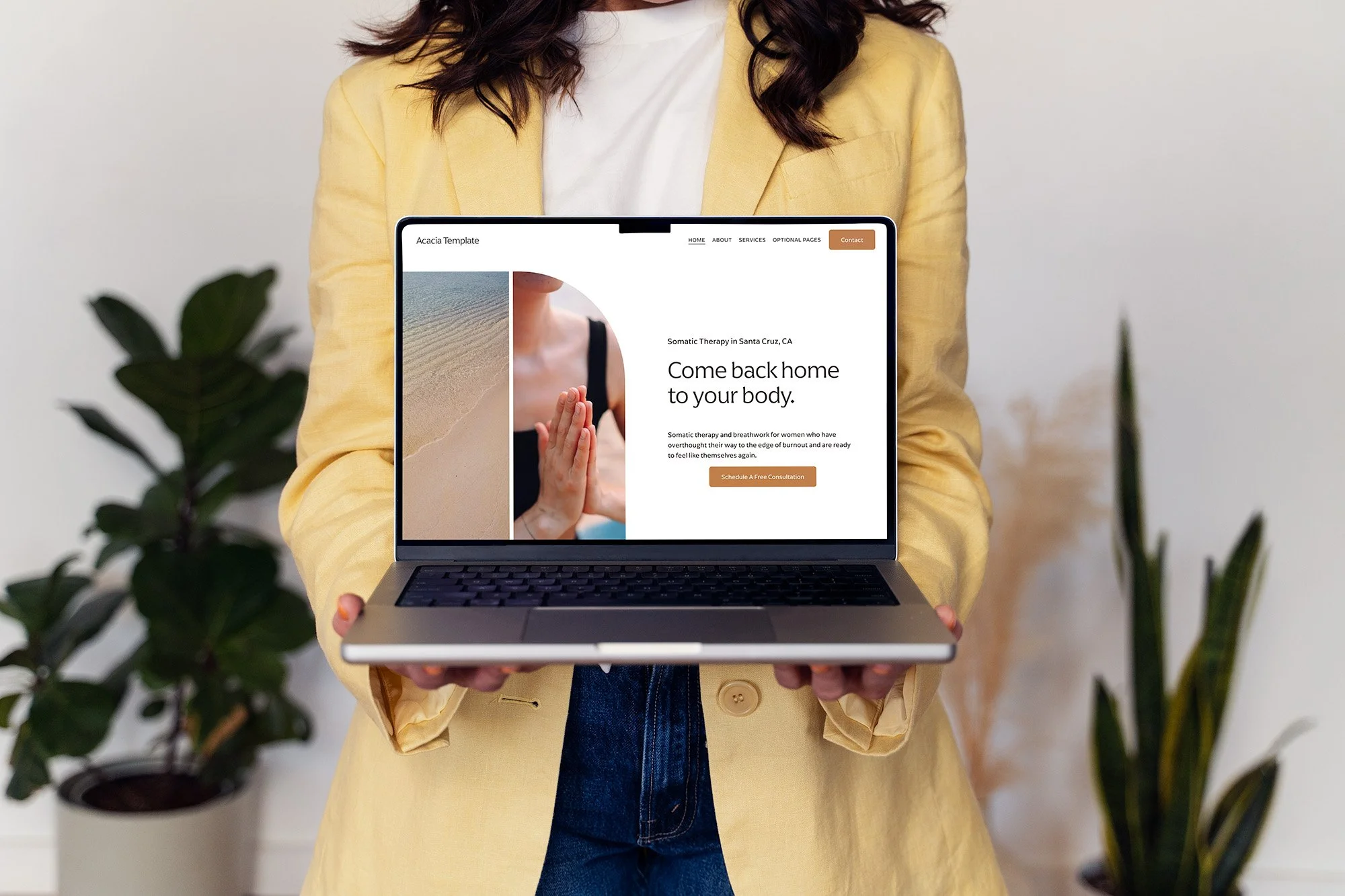 Melissa holding the Acacia Therapist Template on a laptop