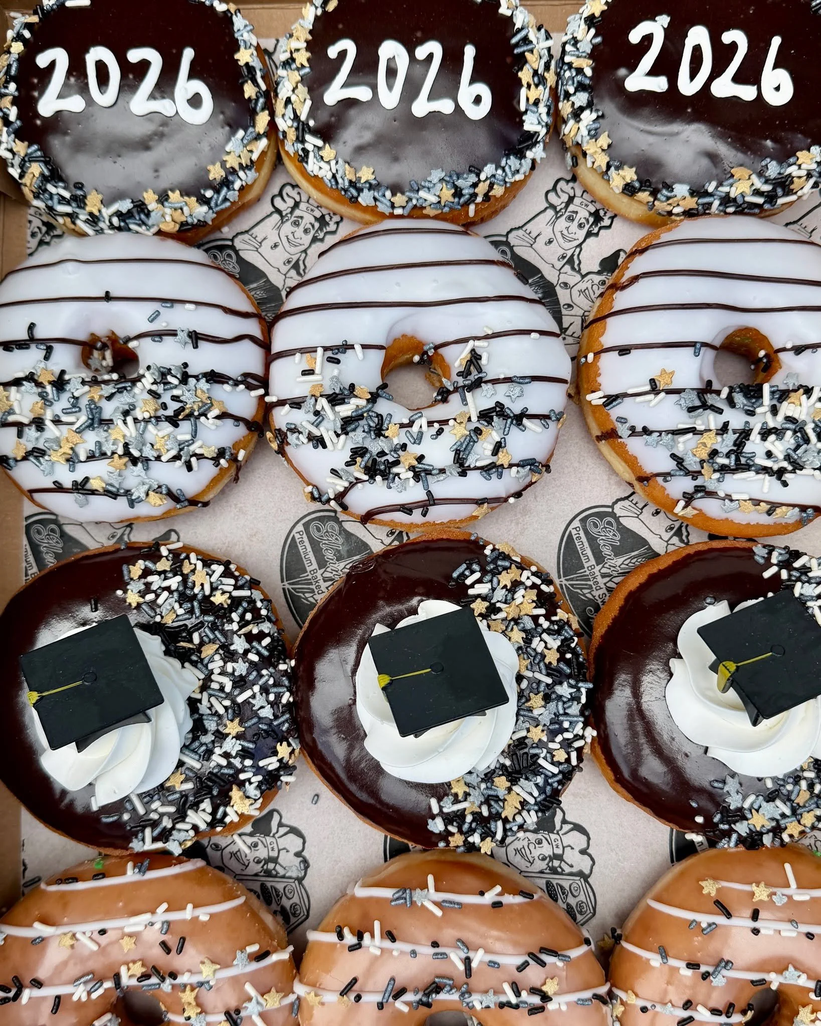 Graduation season is here. Celebrate the Class of 2026 with a graduation-themed dozen from Glenn Wayne Bakery. 🎓🍩📞

This is a preset box and cannot be changed. Three days' notice is required, but we recommend ordering one week in advance due to de