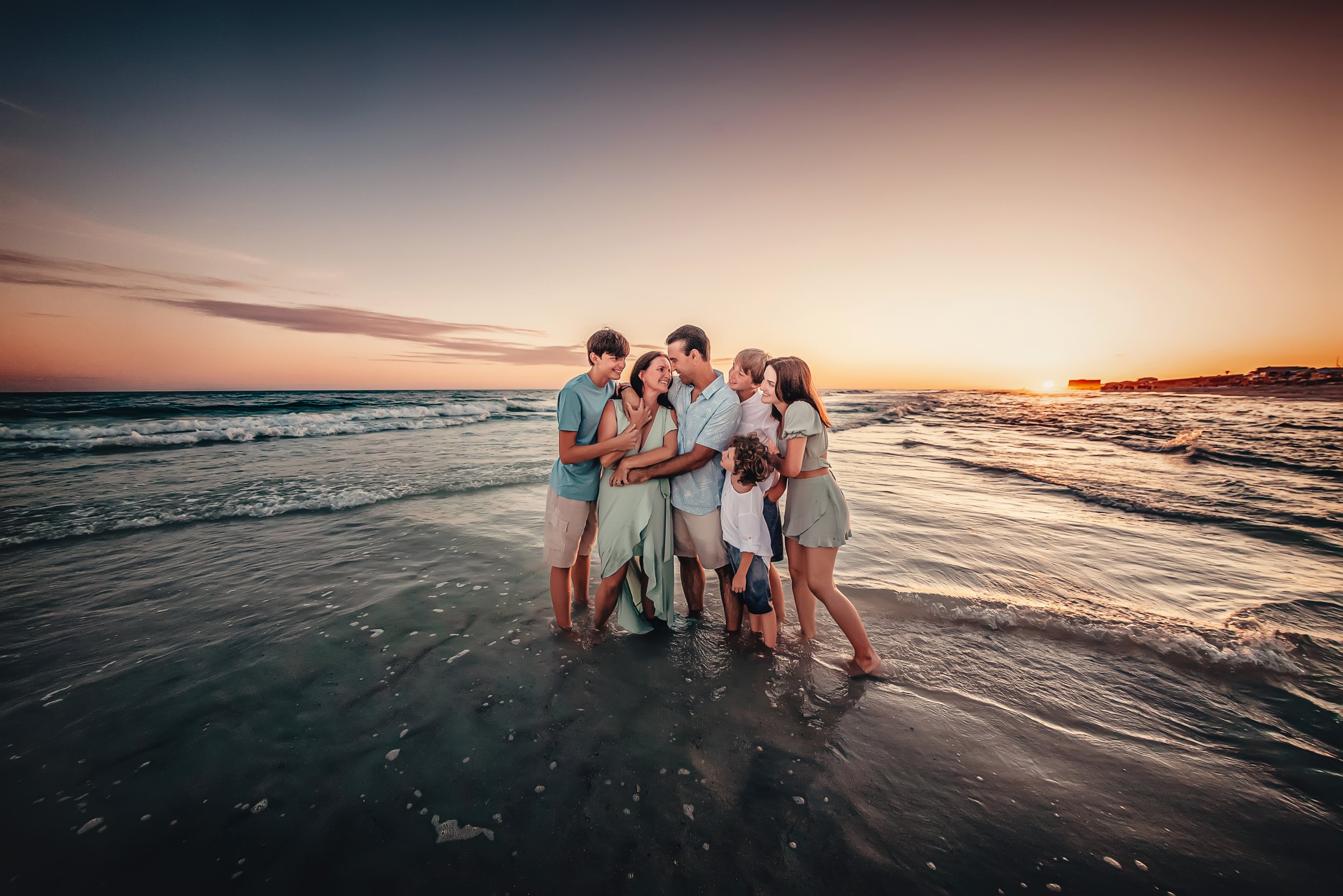 Family gathered on Rosemary Beach for professional family photos.